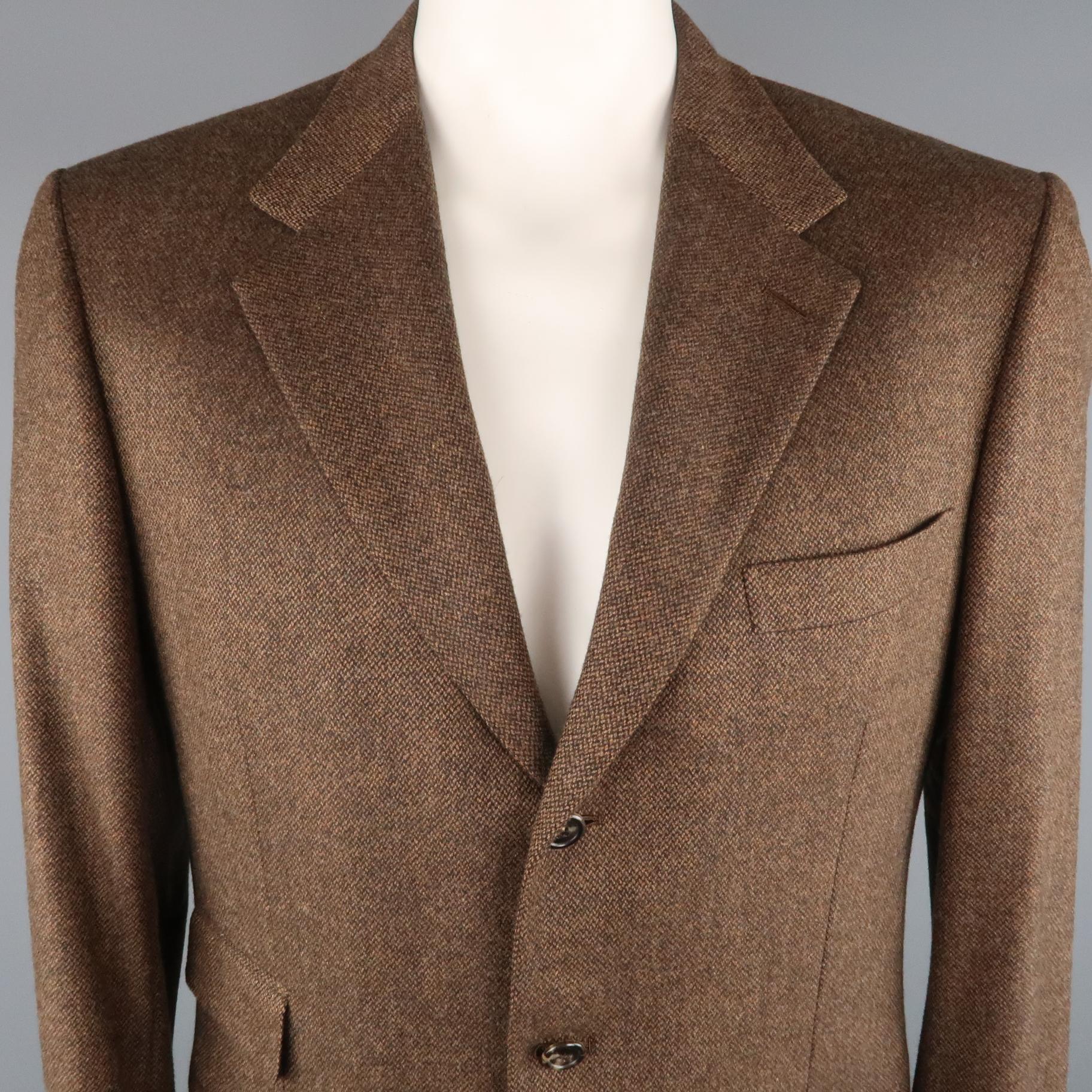 BRIONI Sport Coat comes in brown and black tones in a heather wool / cashmere material, with a notch lapel, slit and flap pockets, 3 buttons at closure, single breasted, and a double vent at back. Wear at lining.  Made in Italy.
 
Excellent  