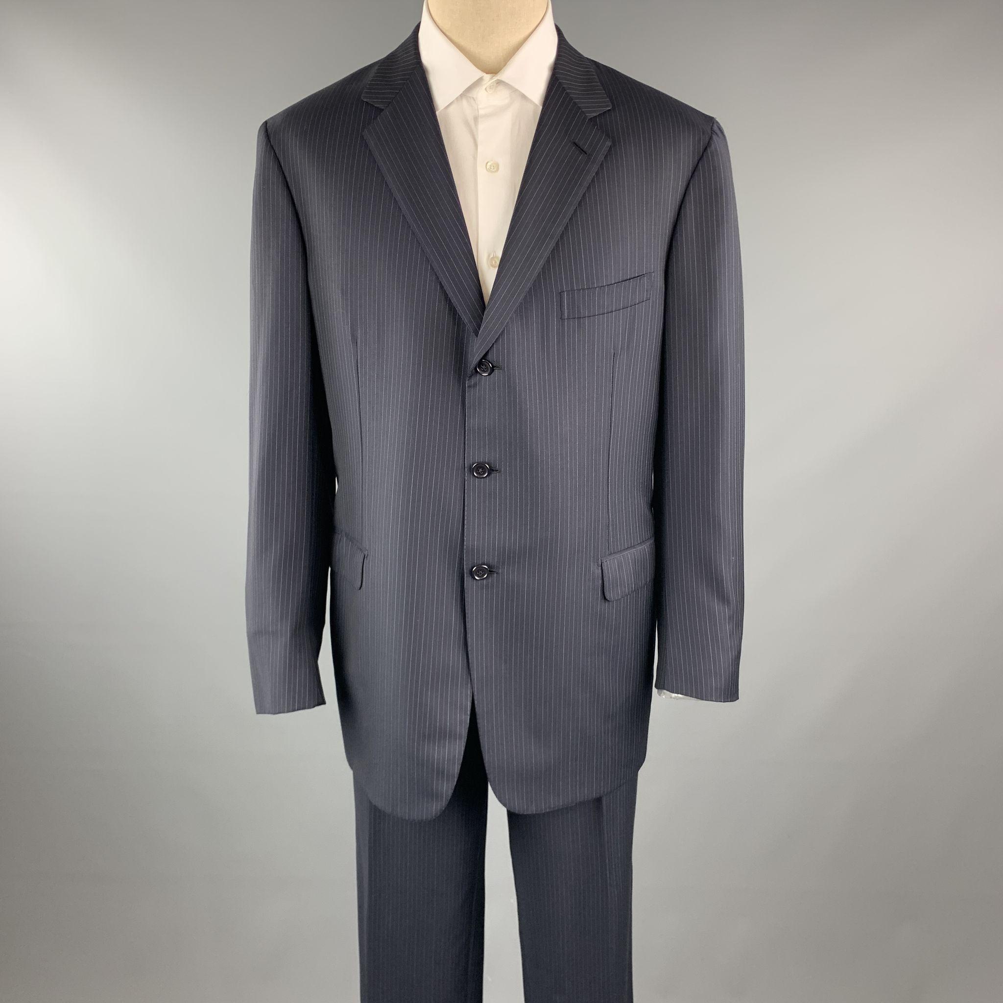 BRIONI suit comes in a navy stripe wool and includes a single breasted, three button sport coat with a notch lapel and matching front trousers. Made in Italy.

Excellent Pre-Owned Condition.
Marked: 46

Measurements:

-Jacket
Shoulder: 19.5