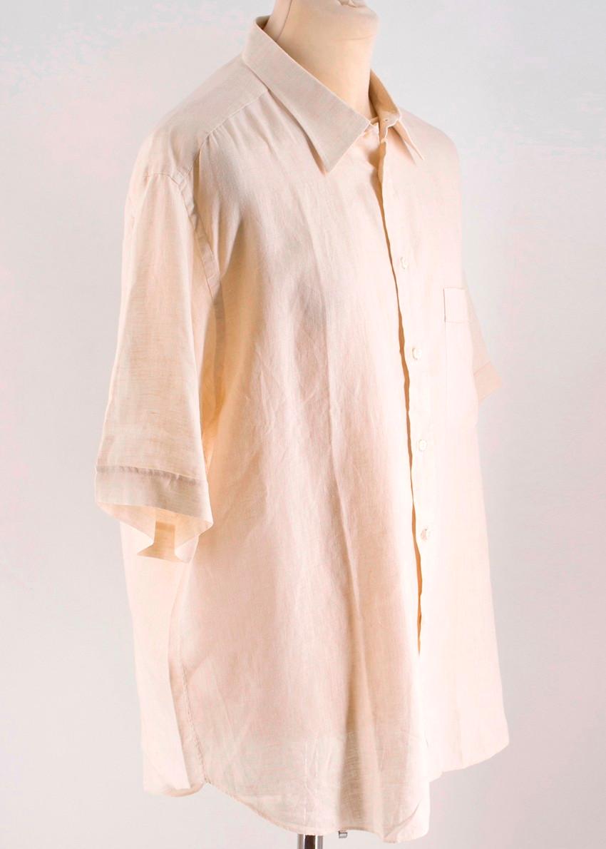 Brioni Beige Linen Shirt
 
 - Beige Shirt
 - 100% Linen
 - Short sleeved
 - Point collar
 - Buttoned down center front
 - Front slip pocket
 - Lightweight
 
 Please note, these items are pre-owned and may show some signs of storage, even when unworn