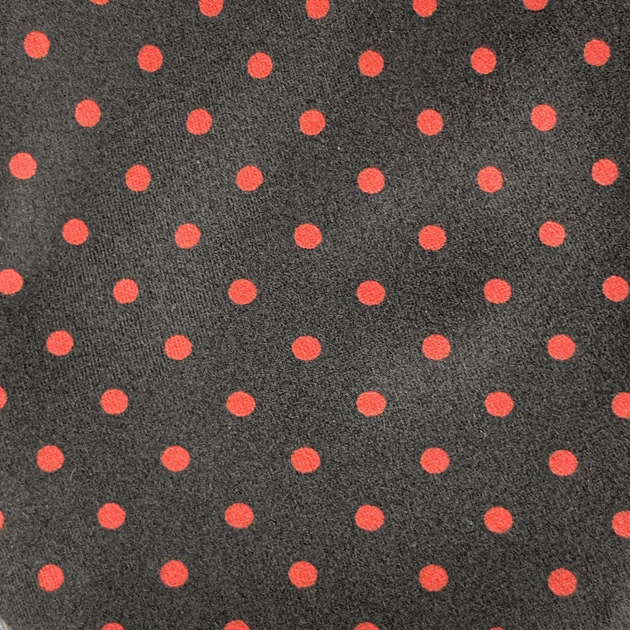 BRIONI necktie comes in black silk with all over red polka dot print. Made in Italy.

Excellent Pre-Owned Condition.

Width: 3.75 in.