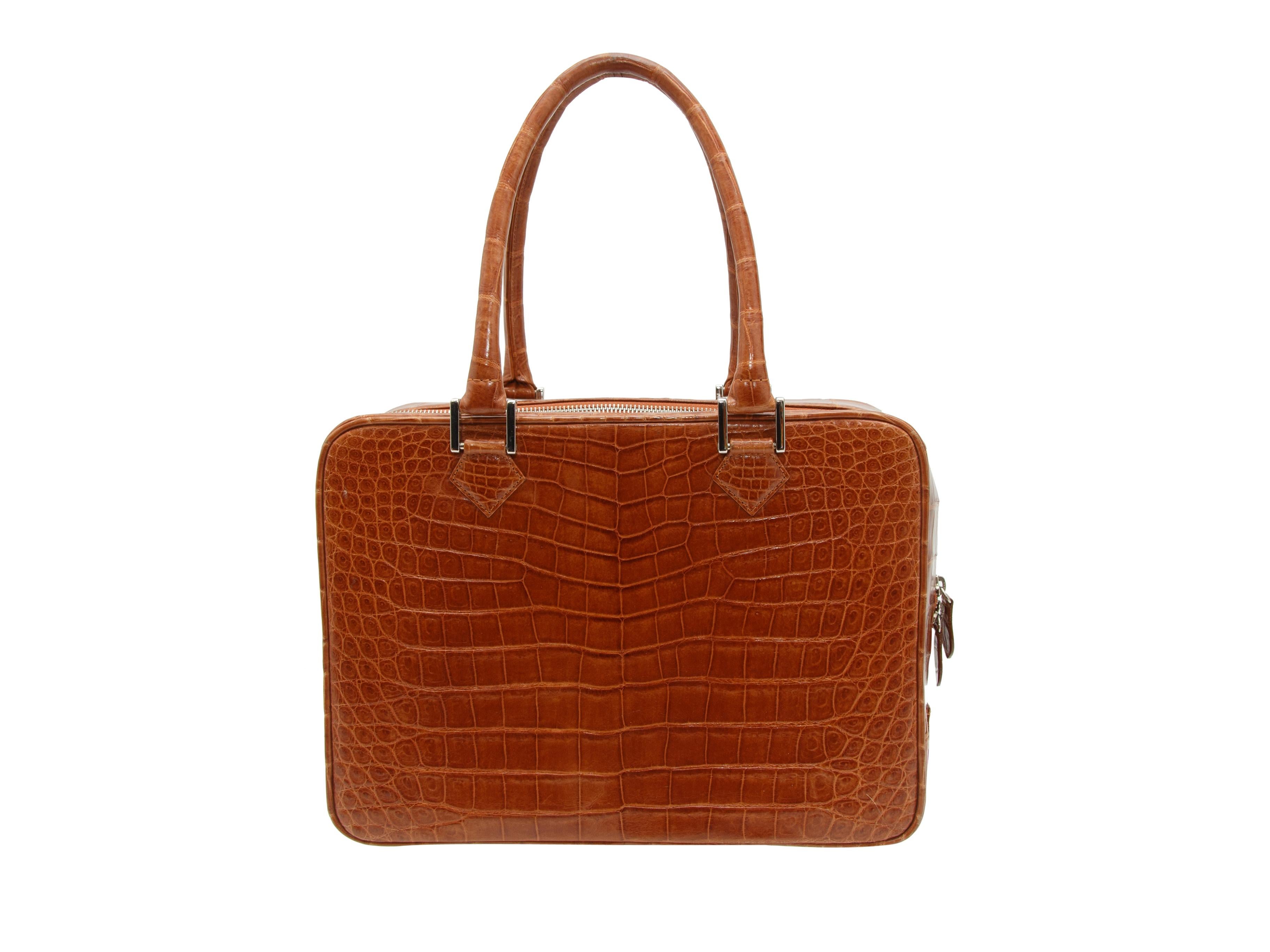 Product details: Brown square alligator handbag by Brioni. Silver-tone hardware. Zip closure at top. 12.5