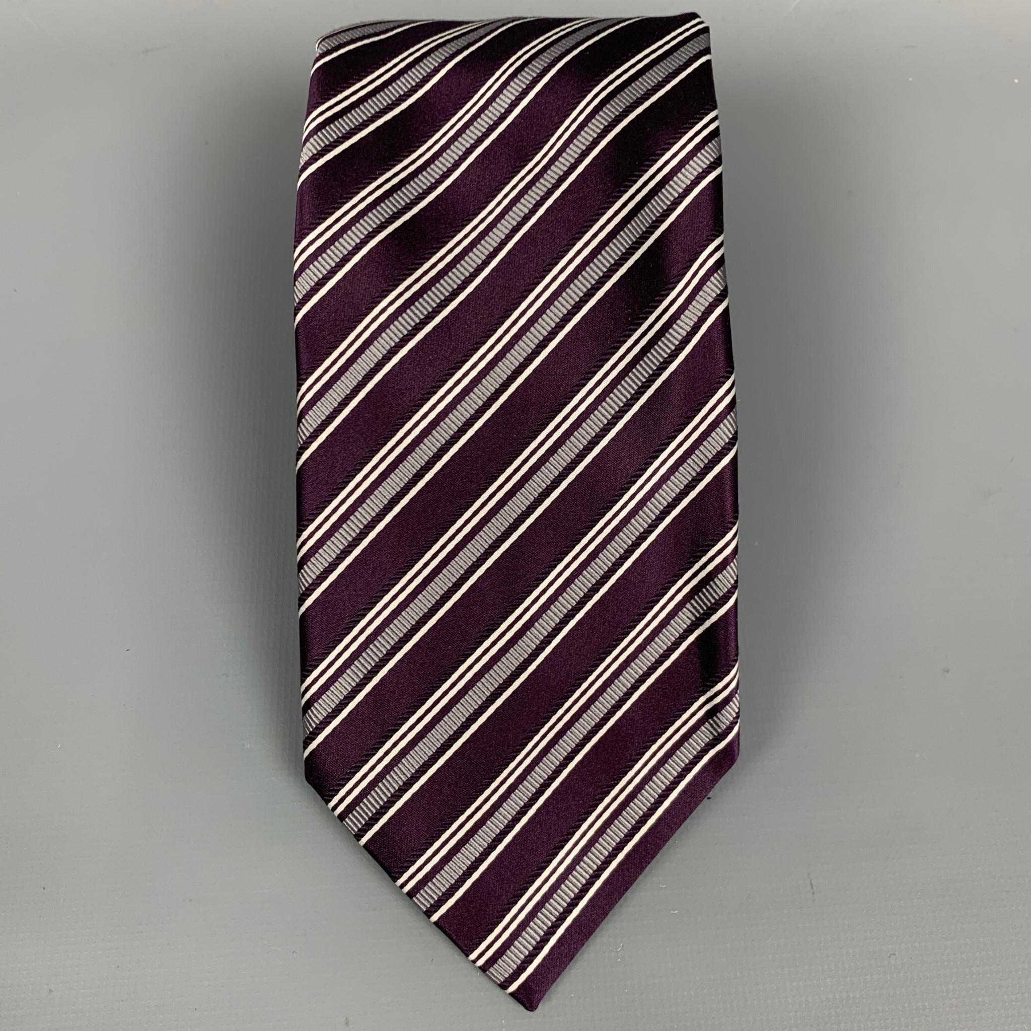 BRIONI neck tie comes in a eggplant & white stripe print silk. Handmade in Italy.

Very Good Pre-Owned Condition.

Measurements:

Width: 3.5 in.  