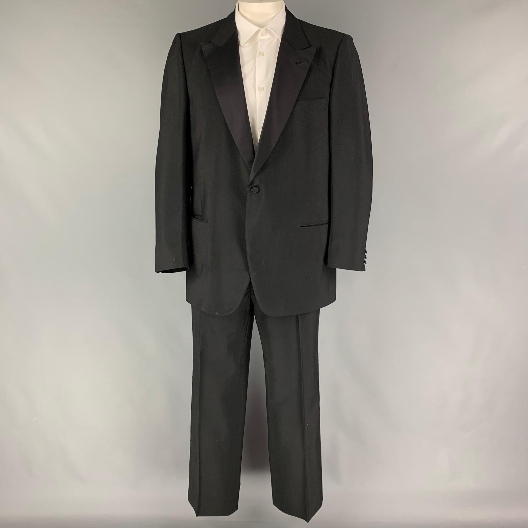 BRIONI for COURTOUE suit comes in a black wool / mohair with a full liner and includes a single breasted, single button sport coat with a peak lapel and matching flat front trousers. Includes suspenders. Made in Italy.

Very Good Pre-Owned