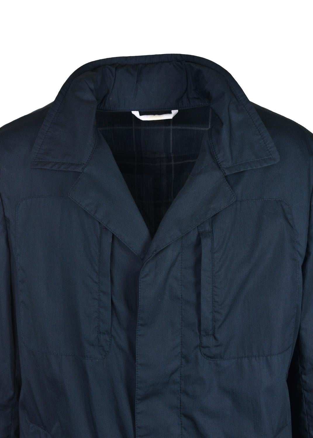 Weather all storms in style with your Brioni Rain Coat. This dark navy essential features a pure cotton base, concealed zip hood with checkered interior, and 4 utilitarian pockets. Brioni incorporates an easy to store feature with the interior full