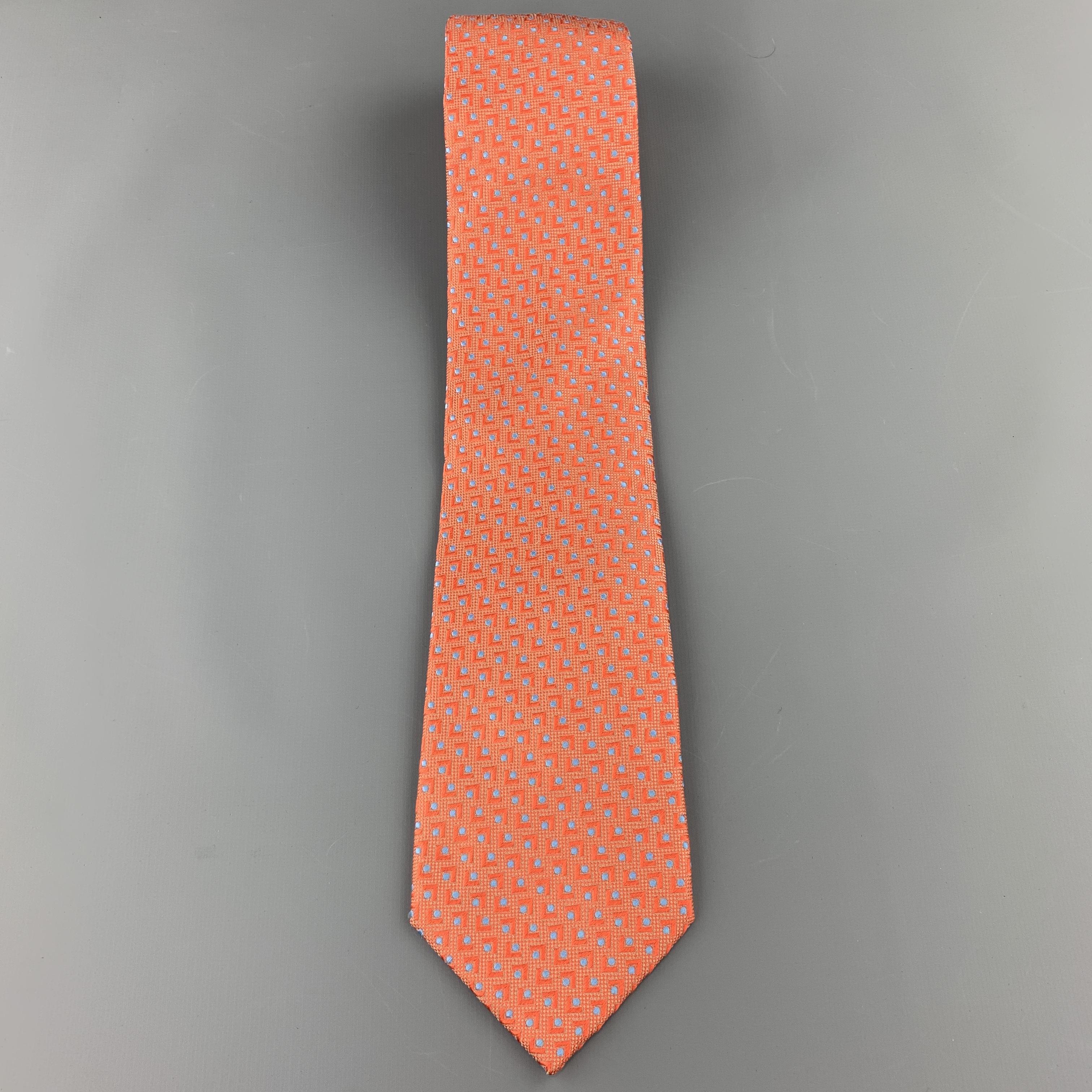 BRIONI necktie comes in orange textured woven silk with all over abstract geometric blue spot print. Made in Italy.

Excellent Pre-Owned Condition.

Width: 3.65 in.  
