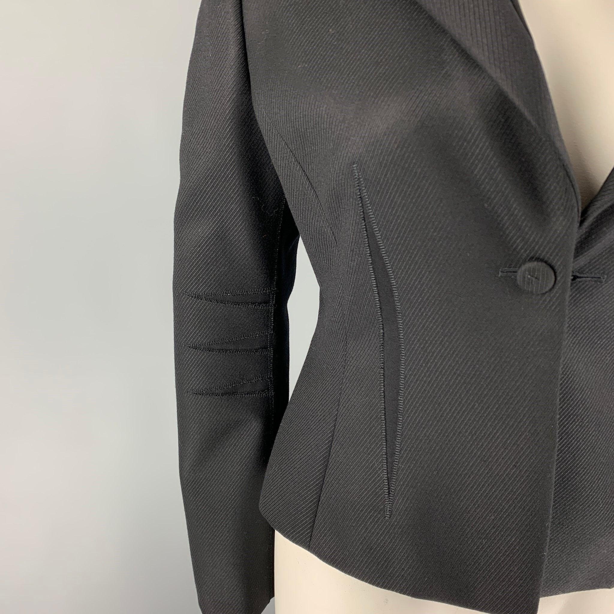 BRIONI jacket comes in a black wool with a full liner featuring a cropped style, double notch lapel design, top stitching designs, and a single button closure.
Excellent
Pre-Owned Condition. 

Marked:   46 R  

Measurements: 
 
Shoulder: 17 inches