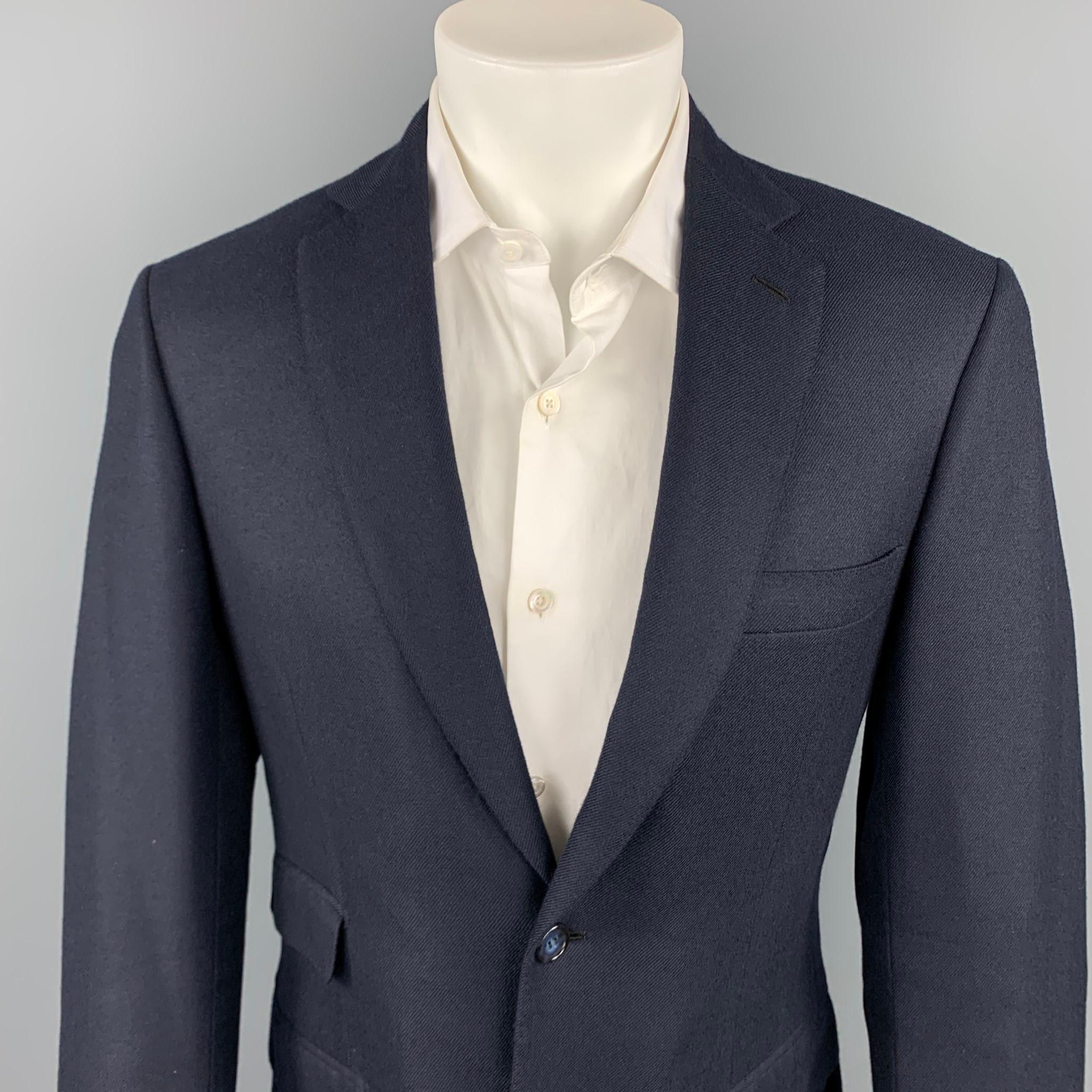 BRIONI custom sport coat comes in a navy cashmere with a full monogram print liner featuring a notch lapel, flap pockets, and a two button closure. Made in Italy.

Very Good Pre-Owned Condition.
Marked: Custom size

Measurements:

Shoulder: 18.5