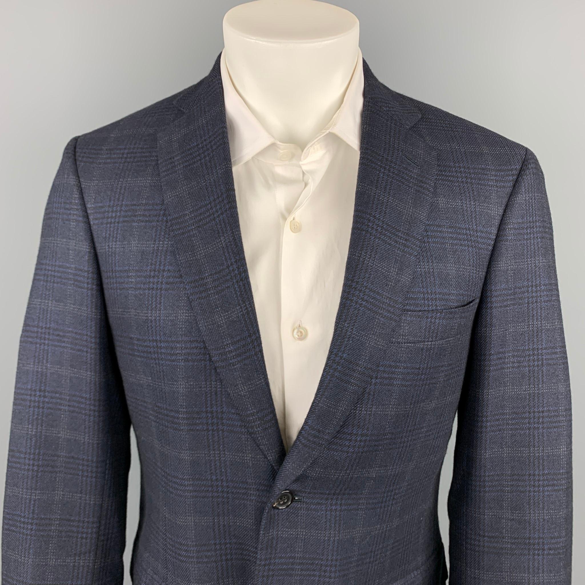 BRIONI custom sport coat comes in a navy plaid silk / wool with a full monogram print liner featuring a notch lapel. flap pockets, and a two button closure. Made in Italy.

Very Good Pre-Owned Condition.
Marked: 39

Measurements:

Shoulder: 18.5