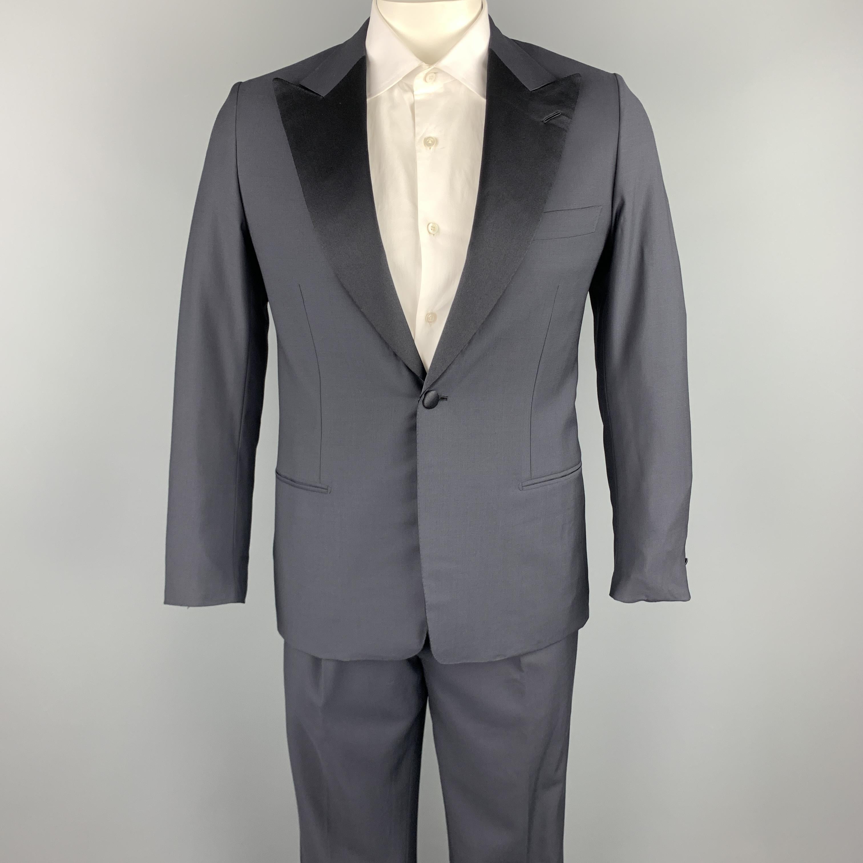 BRIONI x WILKES BASHFORD tuxedo suit comes in a navy wool and includes a single breasted, single button sport coat with a peak lapel, monogram print liner, and matching pleated front trousers. Made in Italy.

Excellent Pre-Owned Condition.
Marked: