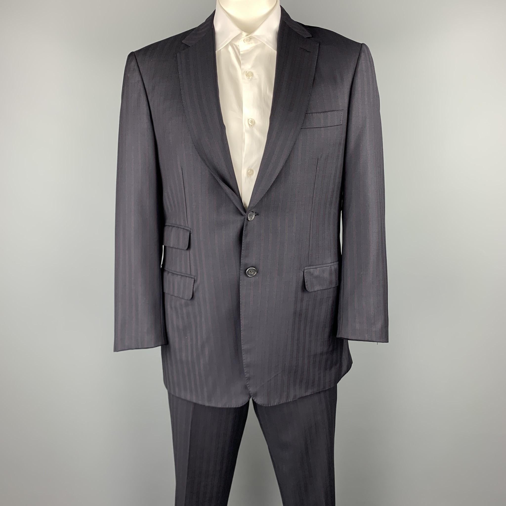 BRIONI suit comes in a navy stripe wool and includes a single breasted, two button sport coat with a notch lapel and matching flat front trousers. Made in Italy.

Excellent Pre-Owned Condition.
Marked: 42 R

Measurements:

-Jacket
Shoulder: 18