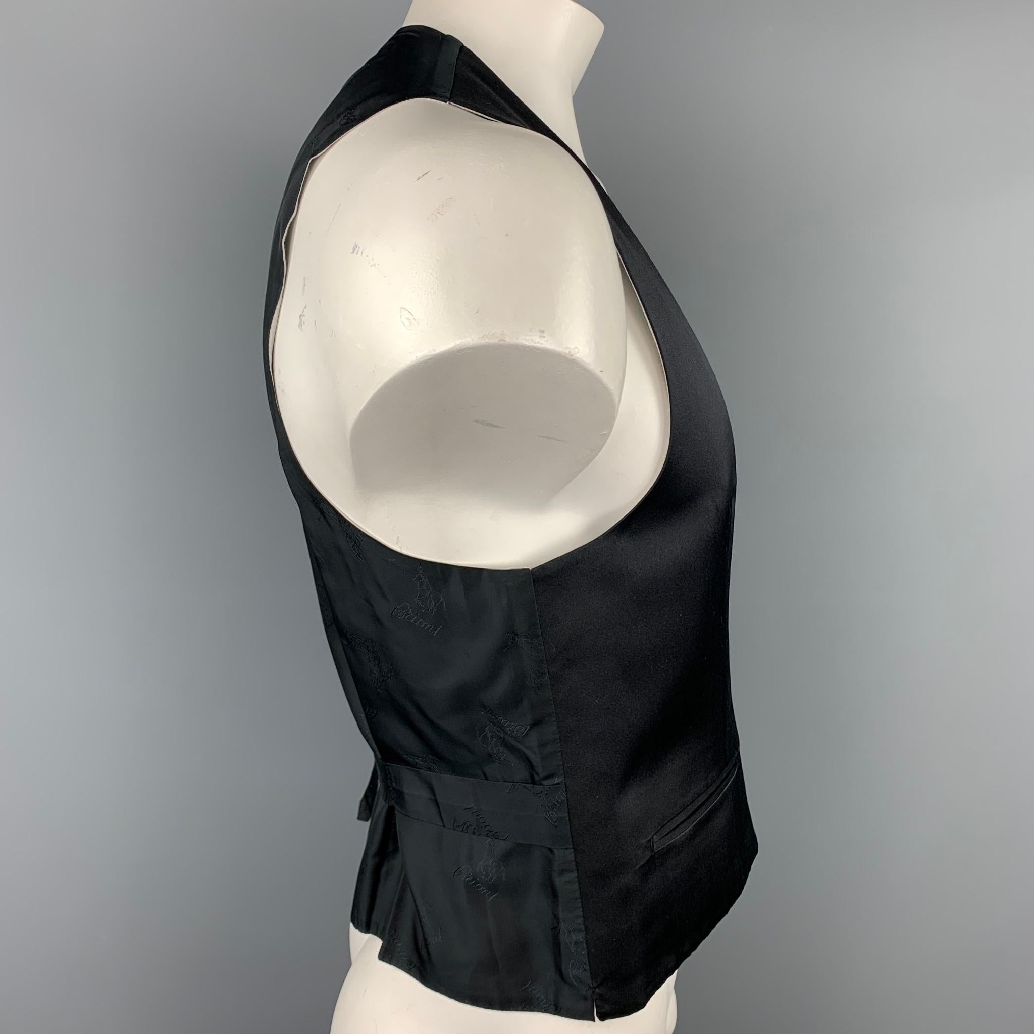 BRIONI formal vest comes in a black silk featuring a deep v-neck, custom made fit, slit pockets, and a buttoned closure.

Very Good Pre-Owned Condition.
Marked: 44 R

Measurements:

Shoulder: 15 in.
Chest: 41 in.
Length: 22.5 in. 