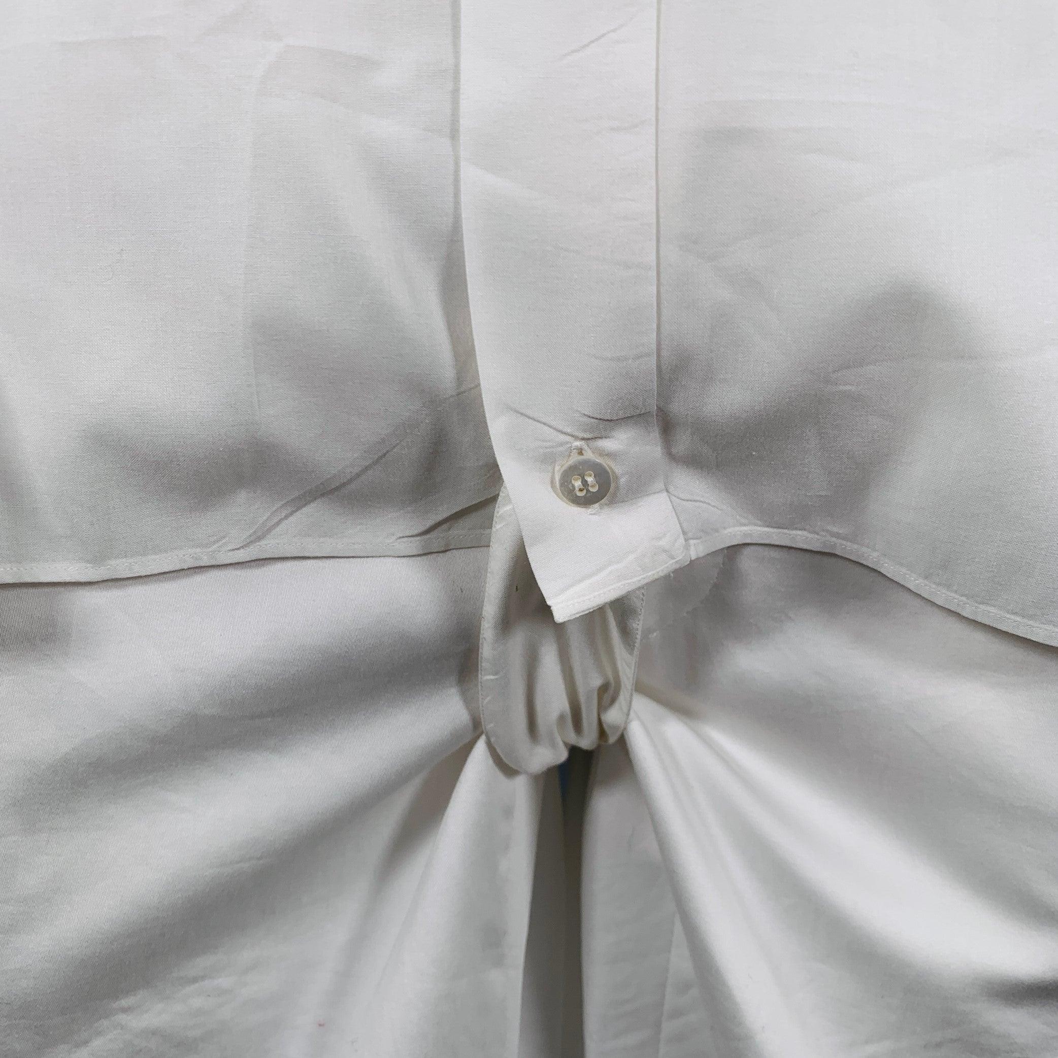 BROINI for NEIMAN MARCUS long sleeve shirt
in a white cotton woven fabric featuring a pleated front with black line details, wingtip collar, French cuffs, and tuxedo stud closure with crotch button closure. Tuxedo studs and cufflinks not