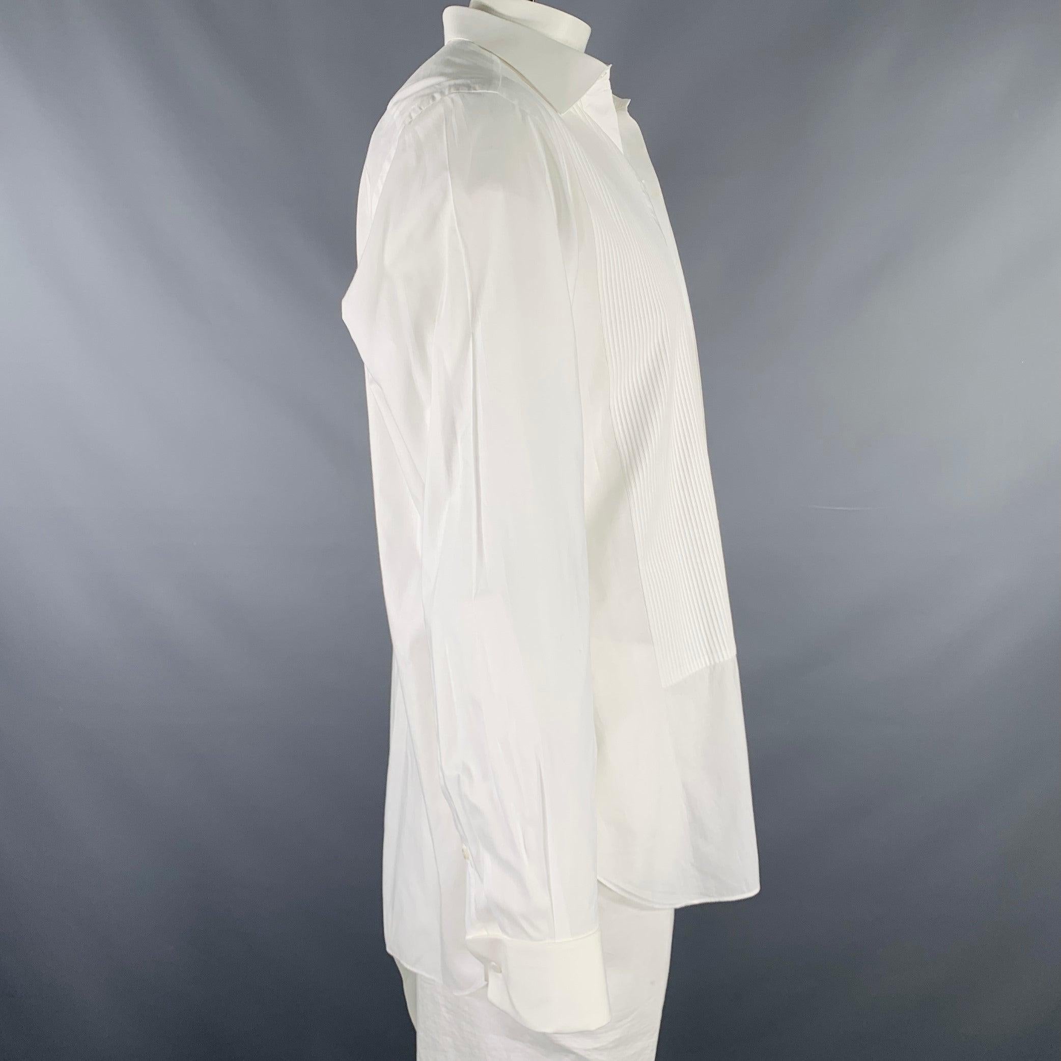 BRIONI long sleeve shirt
in a
white cotton woven fabric featuring a pleated front, French cuffs, crotch button to keep the shirt tucked, and tuxedo stud closure. Comes with a basic set of studs. Made in Italy.Very Good Pre-Owned Condition. Missing