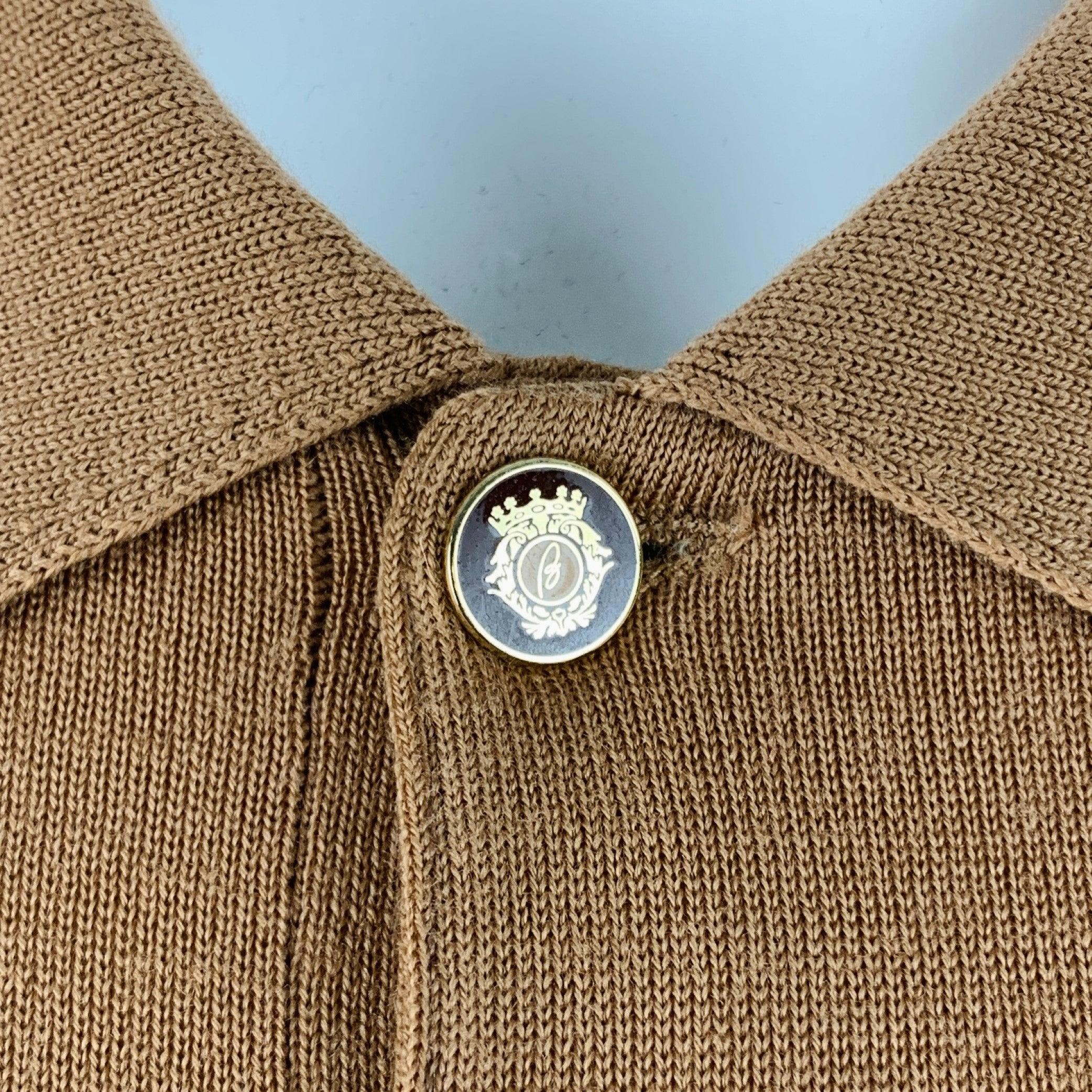 BRIONI polo in a tan knit fabric featuring spread collar, long sleeves, and half placket button closure with Brioni monogram buttons. Made in Italy.Very Good Pre-Owned Condition. Minor hole in right shoulder. 

Marked:   size not marked. Tags