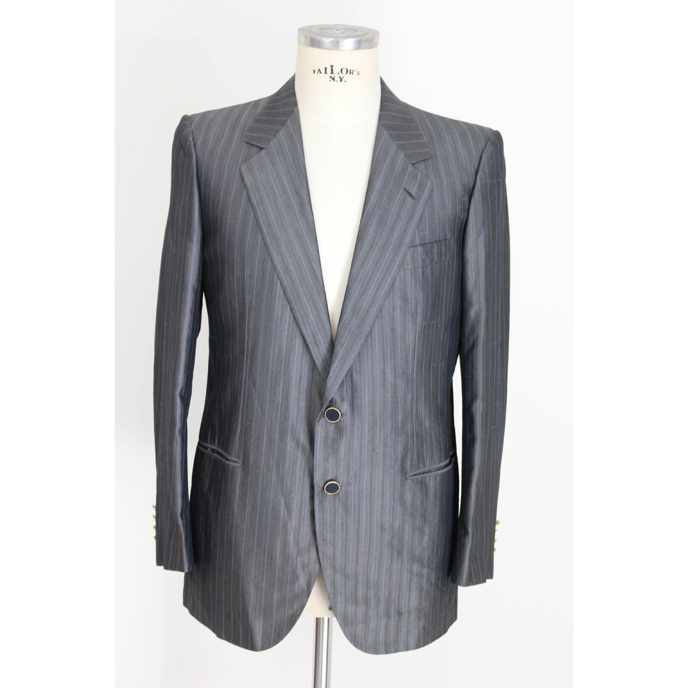 Brioni Roman Style complete for men. The Condotti model jacket, Snello model trousers. Gray and light blue jacket and trousers. Classic two-button jacket with two pockets on the sides and a chest pocket, fully lined and logoed, dark blue enamelled