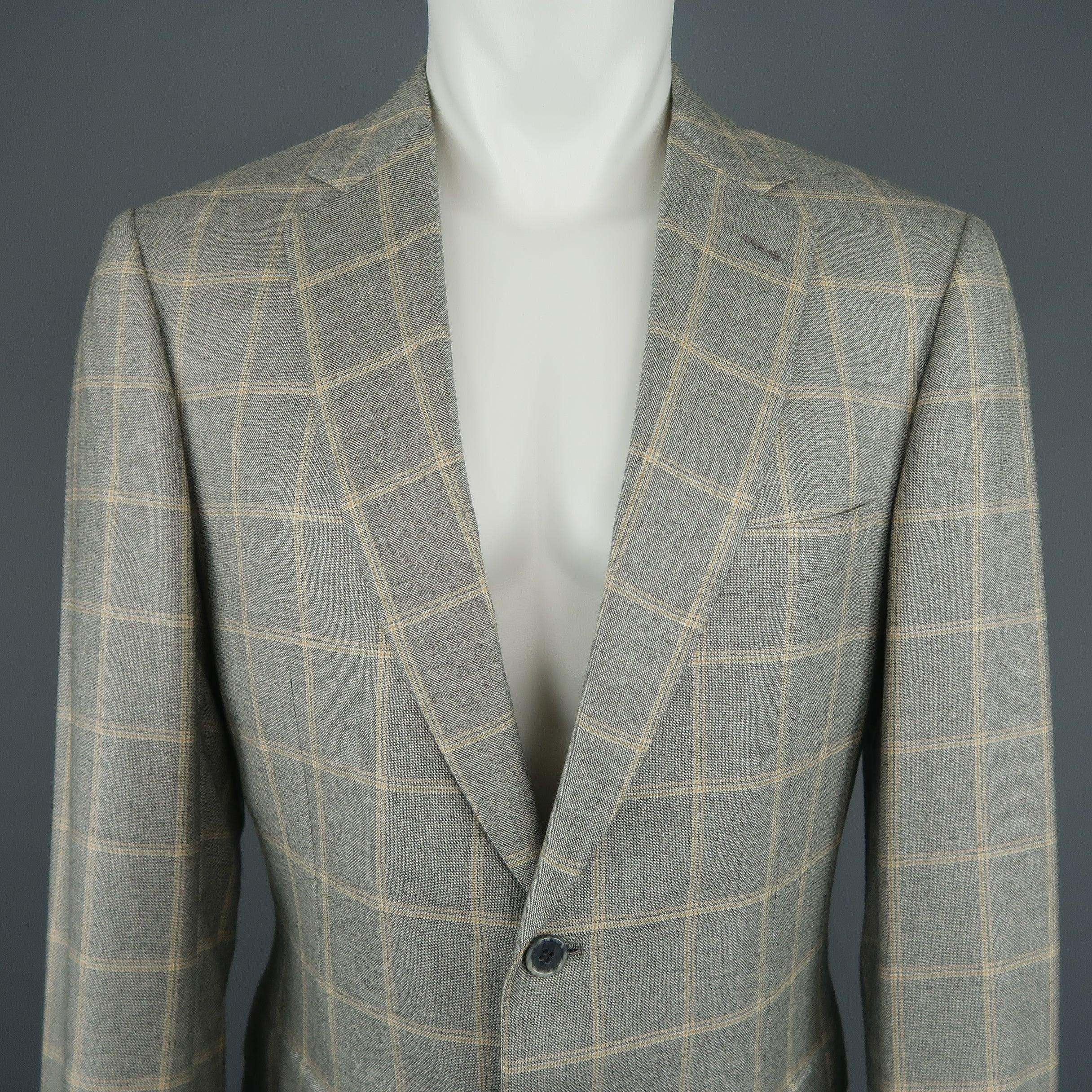BRIONI sport coat jacket comes in silk wool blend light gray and gold windowpane fabric with a single breasted two button closure, notch lapel, and functional button cuffs. Made in Italy.Excellent Pre-Owned Condition. 

Marked:   40 R