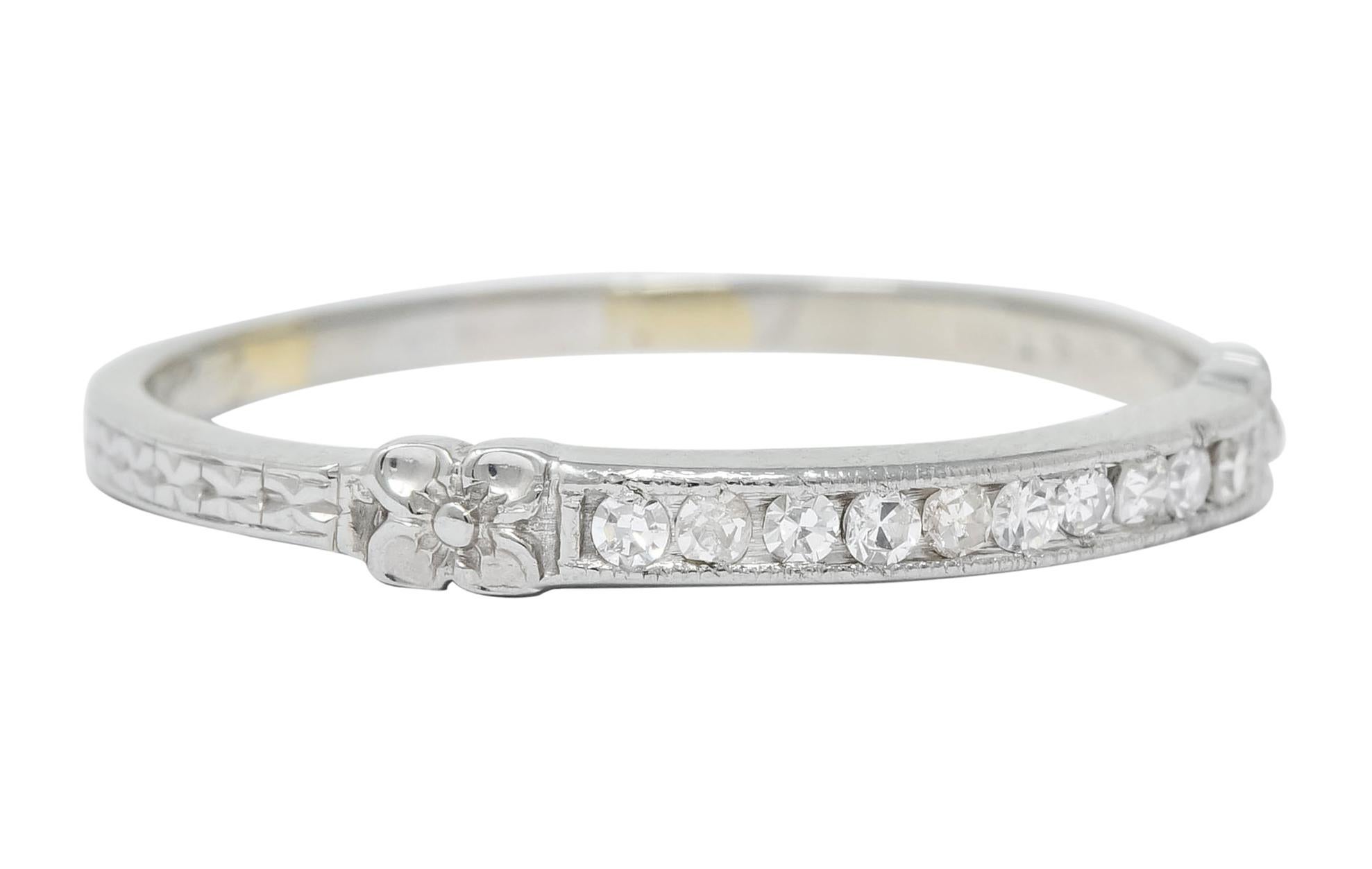 Centering ten single cut diamonds, set to front in a milgrain channel, weighing approximately 0.20 carat; eye-clean and white

Flanked by highly rendered orange blossoms accenting each end of channel

With deeply engraved shoulders depicting a