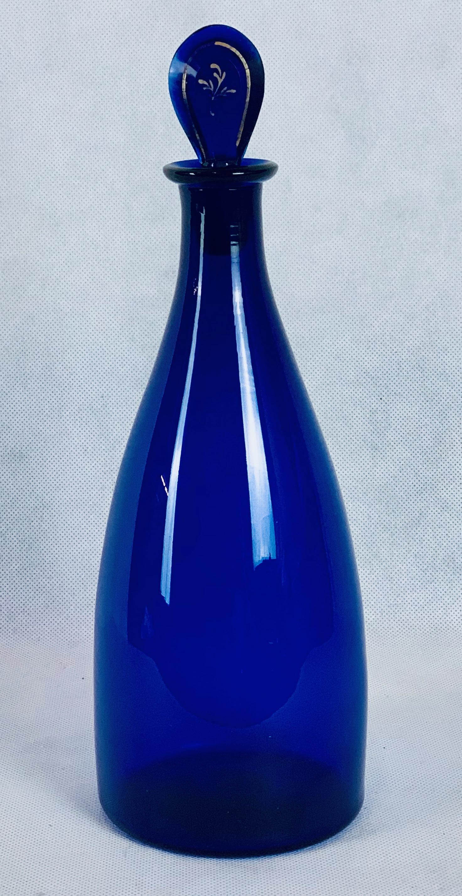 Georgian Bristol/cobalt blue Indian club or plain tapered decanter with lozenge shaped stopper. Hand blown with pontil on the underside. The gilt decoration on the stopper reveals an 