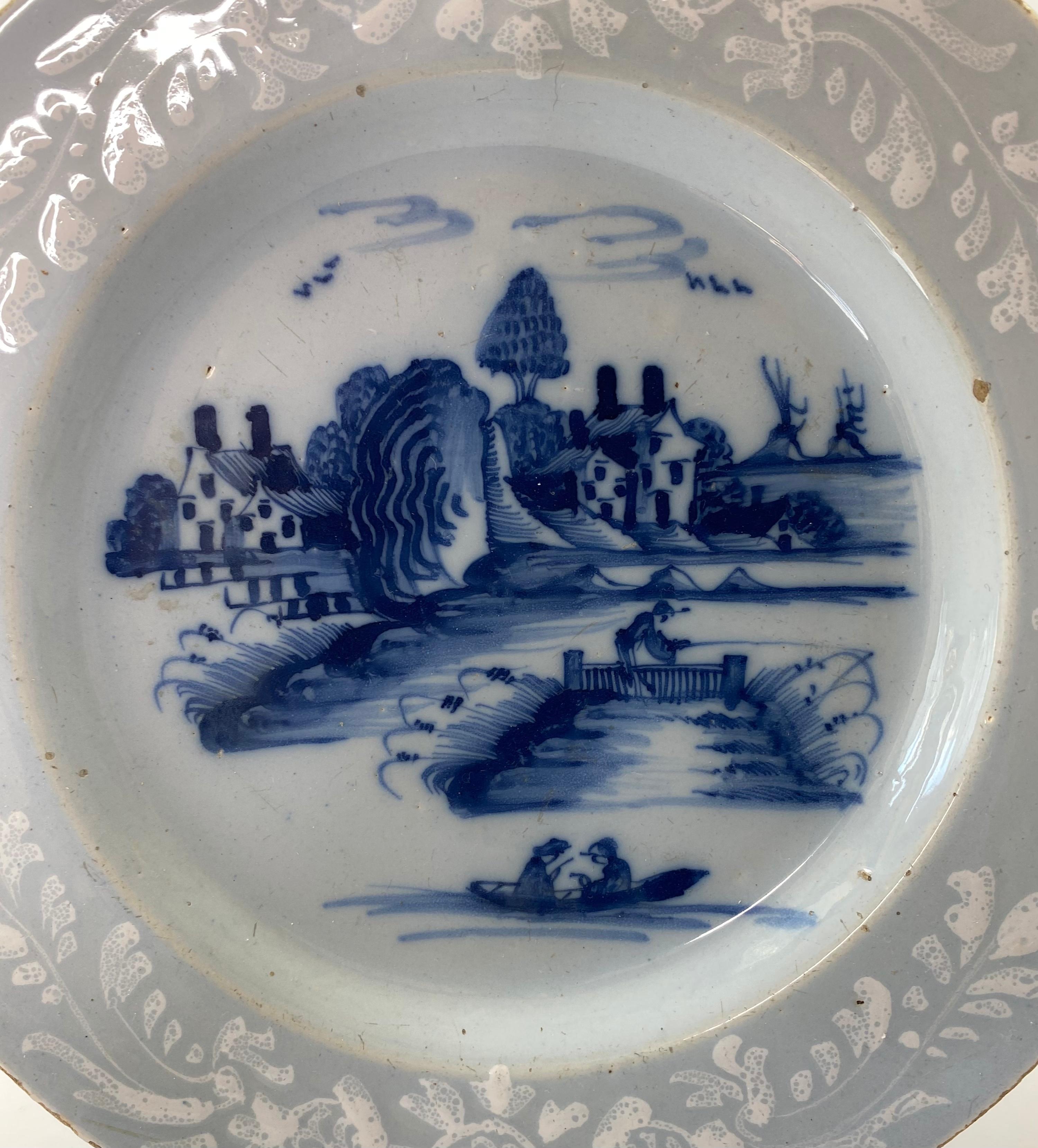 Bristol delft ‘Bianco sopra Bianco’ dish, Redcliff Back, Richard Frank’s factory, c. 1760. Painted to the centre in underglaze blue, with a scene of fishermen, in a European landscape. Within a border, enamelled in white with stylised floral