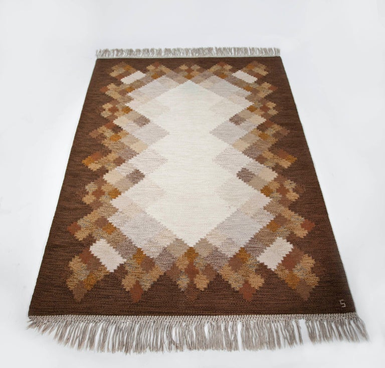Brita Svefors brown and tan flat-weave rug 