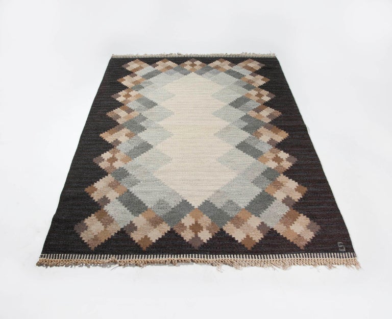 Brita Svefors dark blue and brow flat-weave rug 