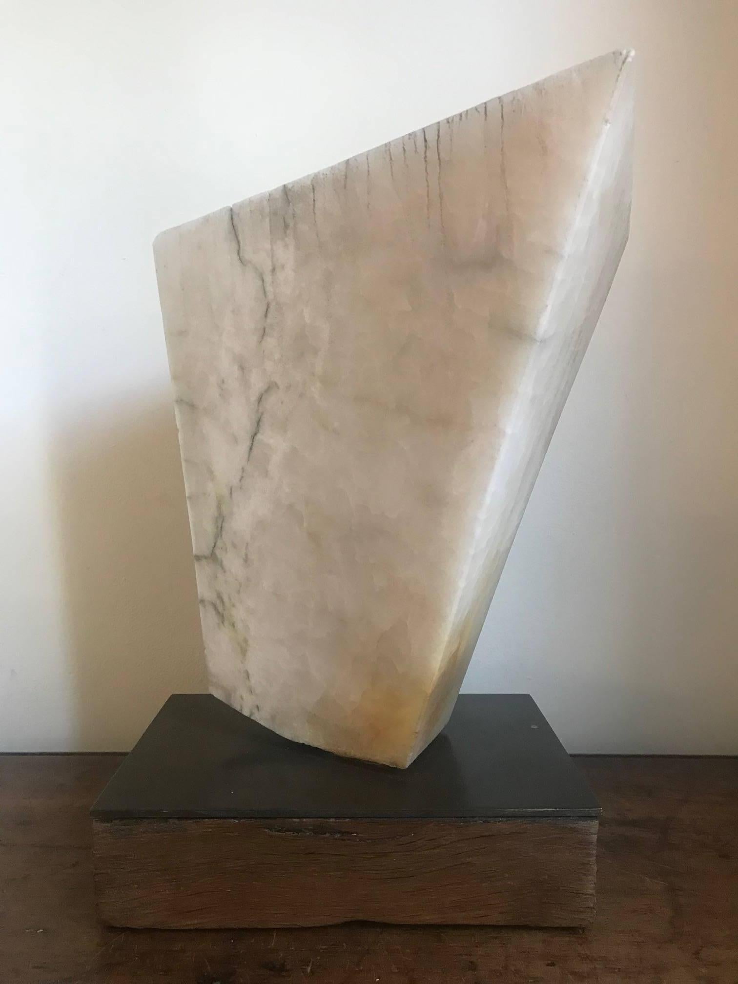 An abstract marble sculpture mounted on a wood and bronze base. Unsigned British, circa 1960s.