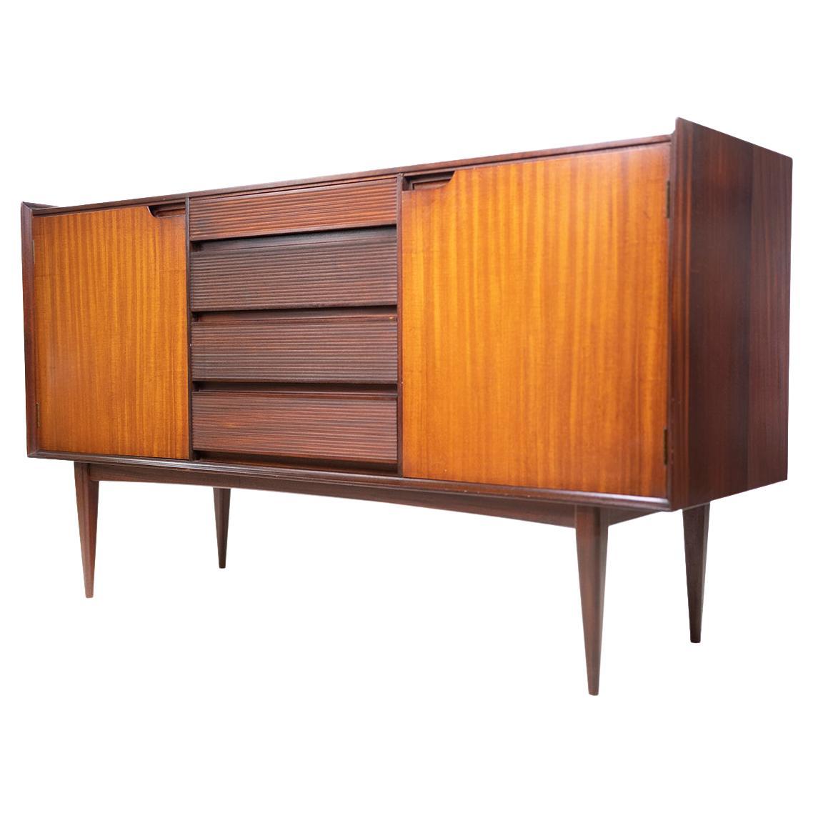 Mid-century sideboard by Richard Hornby

British mid-century Afromosia teak sideboard by Richard Hornby for Fyne Ladye in the 1960s and retailed through Heals. Superb craftsmanship throughout, carved from solid from Afrormosia with beautiful