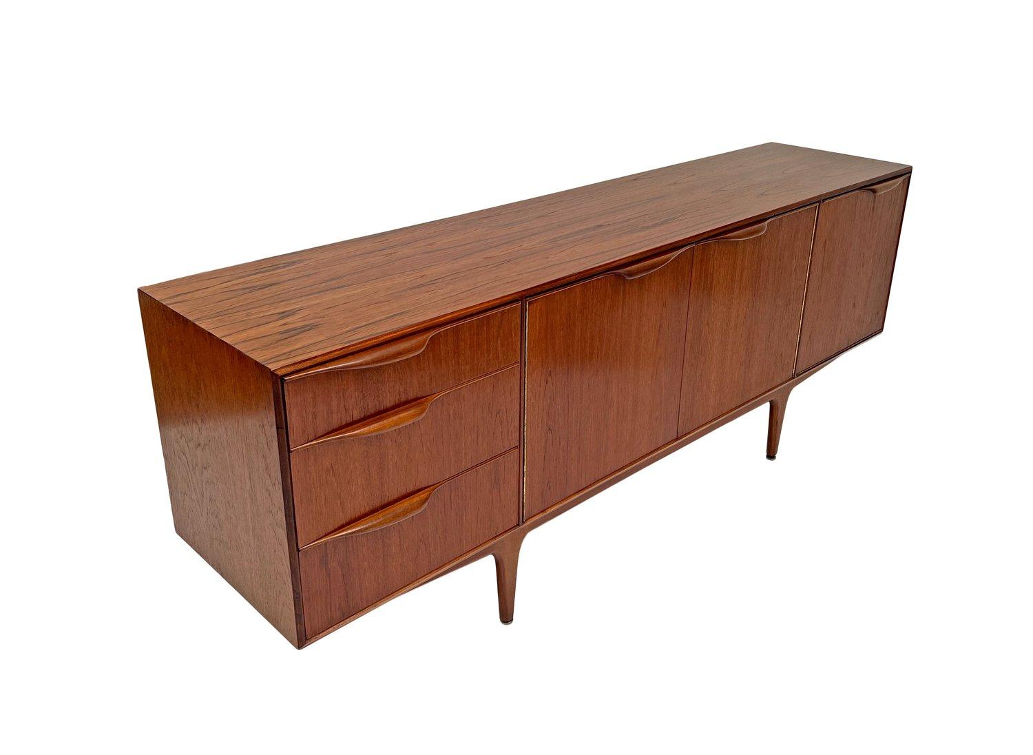 A beautiful British teak sideboard ‘Dunvegan’ by A.H McIntosh of Kirkcaldy, this would make a stylish addition to any living or work area.

The sideboard has a drop down cupboard with shelf to the right, two cupboards to the centre and a bank of
