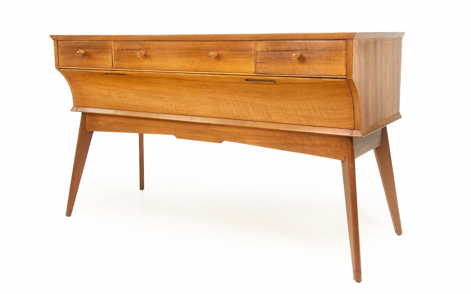 Alfred Cox mid century sideboard

Alfred Cox walnut sideboard on raised splayed legs, this item was made by a highly collectable cabinet maker.

Alfred Cox was a great designer of post-war British furniture. He worked mainly with walnut and