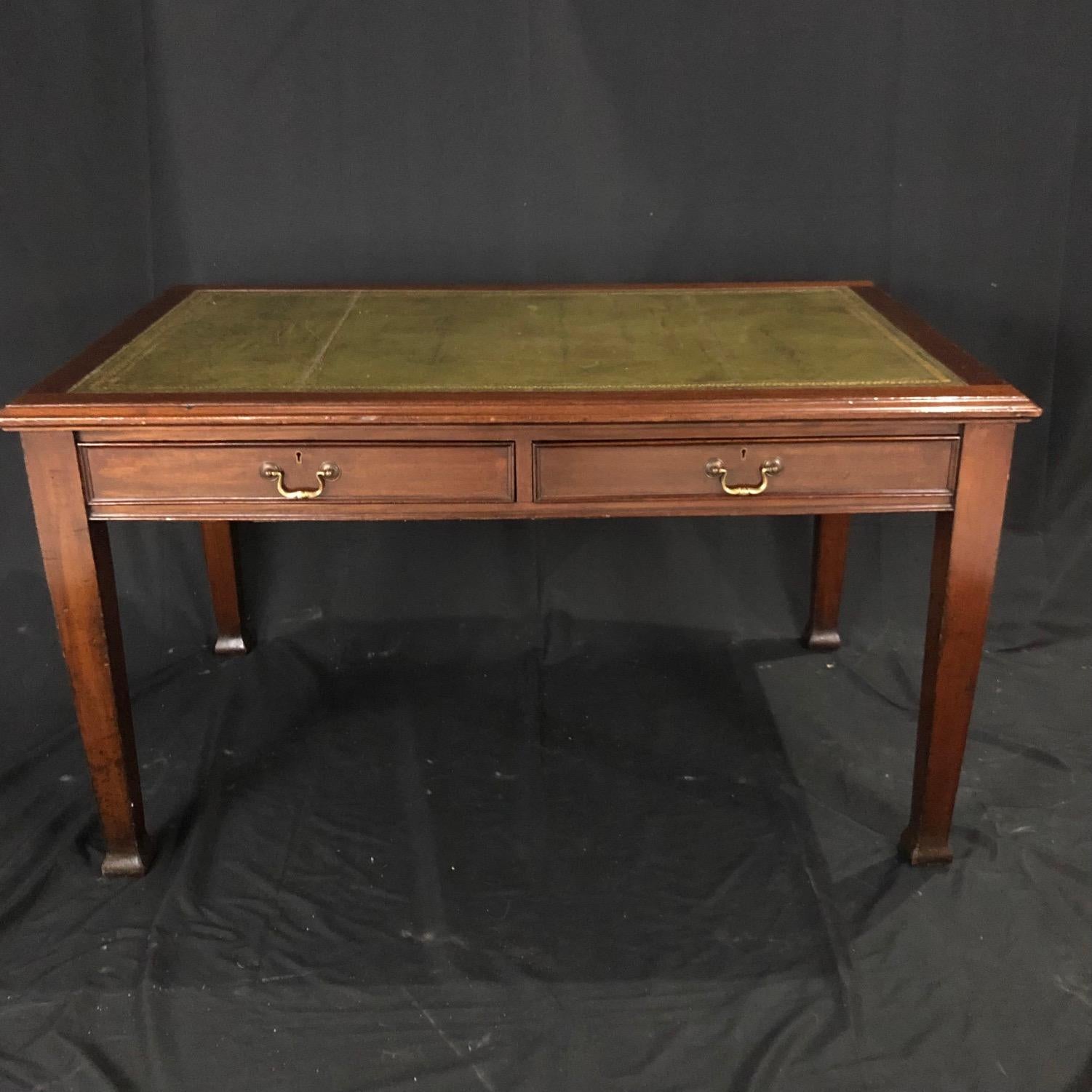 This beautiful desk has a wonderful aged patina and is quite solid, with two large dovetailed drawers. Crafted in the beginning of the 20th century, it is paneled on all sides so can stand in the center of a room as well as against a wall. The