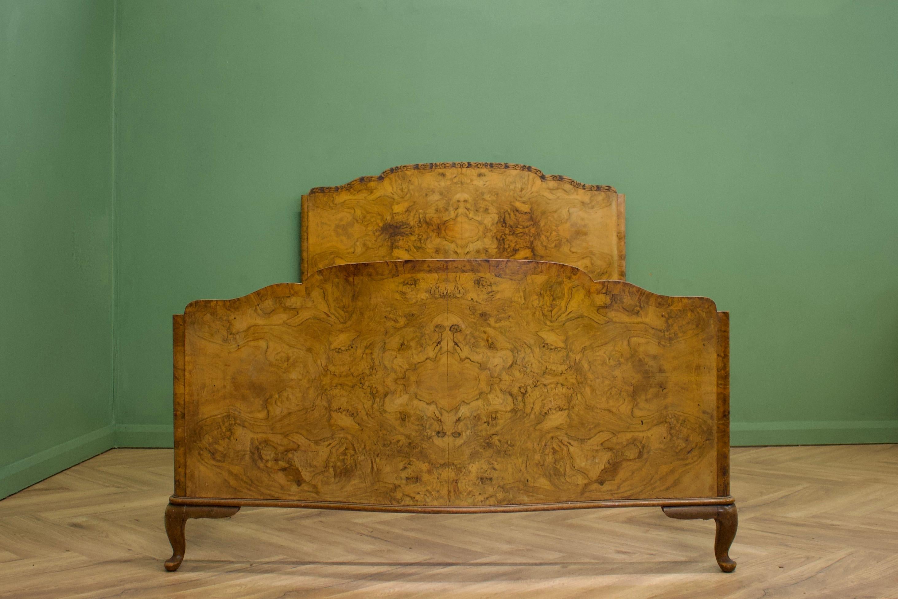 A beautiful, art deco burr walnut bed frame 
Standing on Queen Ann legs, the foot board has a serpentine shape and also features beautiful carved detail to the headboard


It will fit a standard UK double bed base (inside measurements 138cm wide and