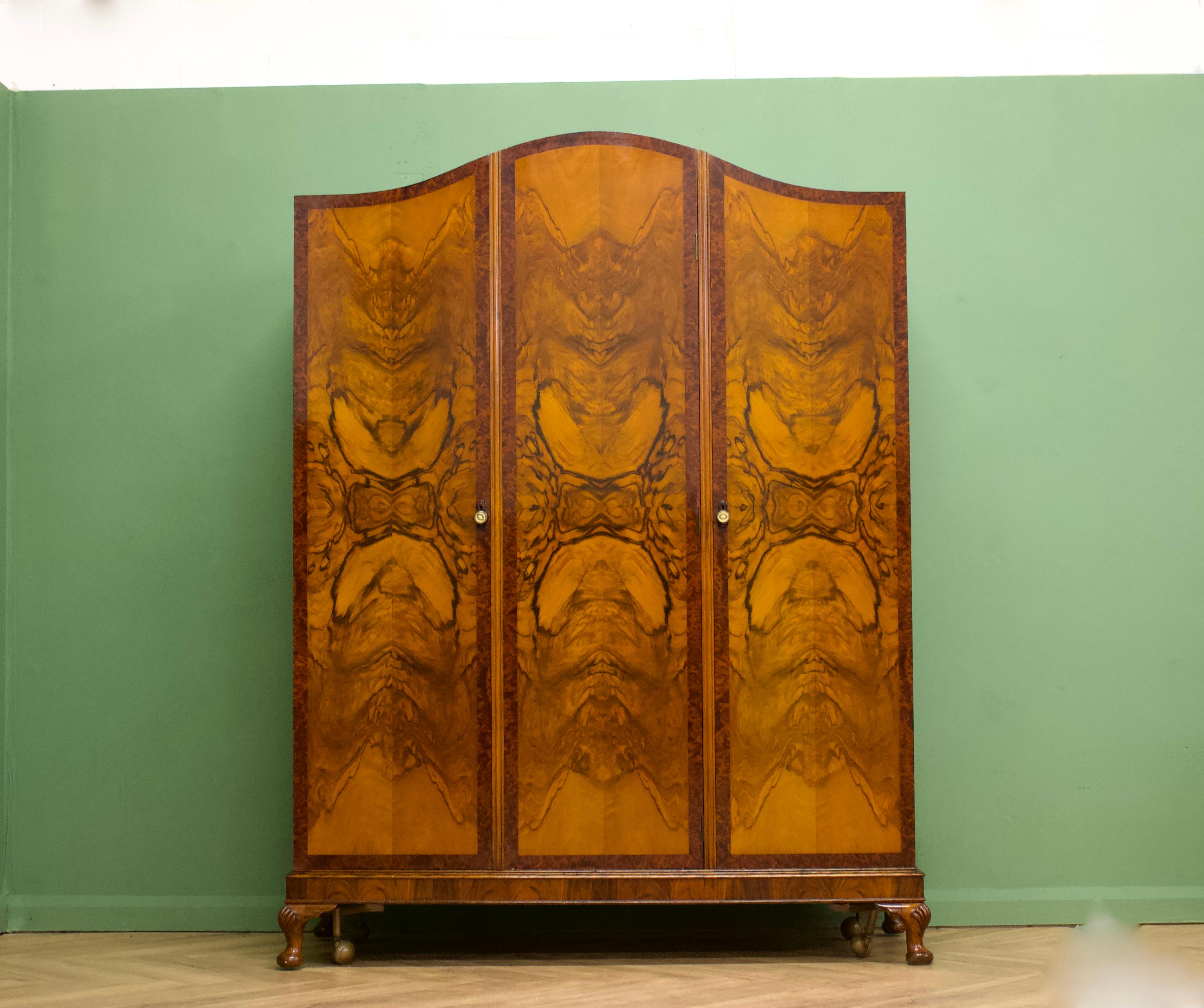 - Art Deco wardrobe
- Manufactured in the UK - in the style of Waring and Gillow
- Made from solid wood and burr walnut veneers
- The wardrobe sits on castors which are removable
- Featuring internal full length mirrors, a hanging rail, shoe