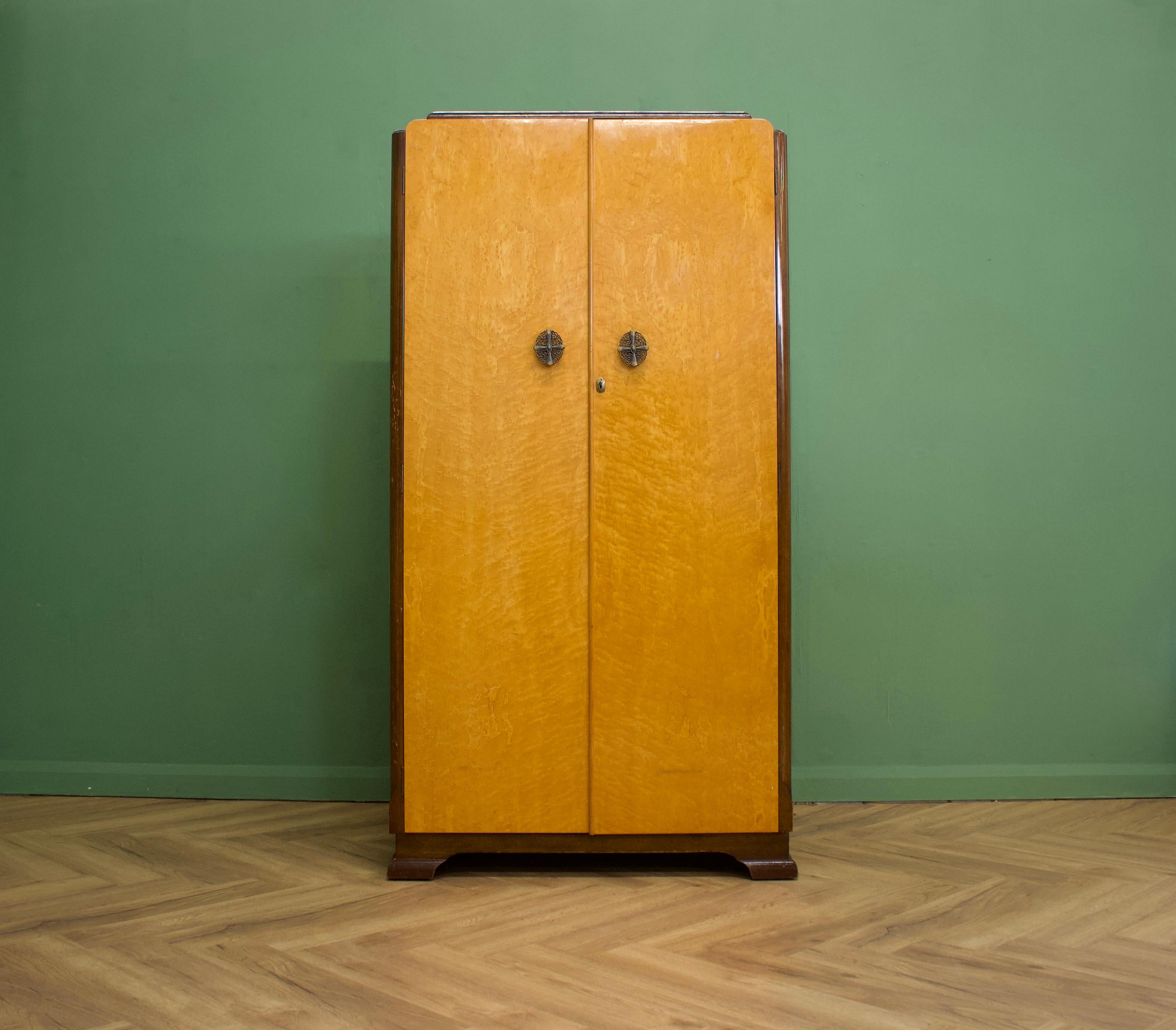 A 1940s Art Deco style birdseye maple wardrobe

Featuring a pull out hanging rail and shelves.