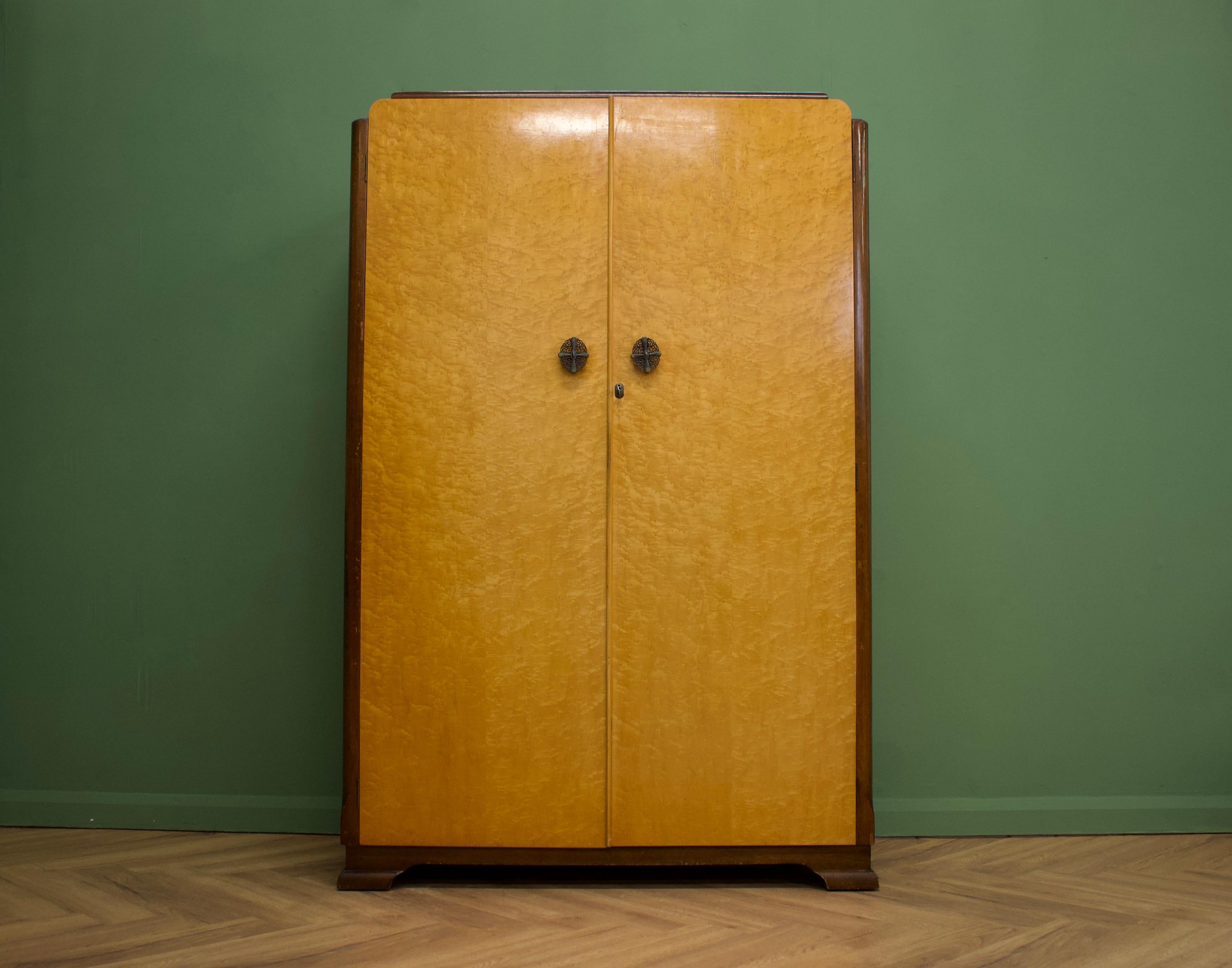 A 1940s Art Deco style birdseye maple wardrobe

Featuring two rails and a shelf

This wardrobe can separate in two halfs.