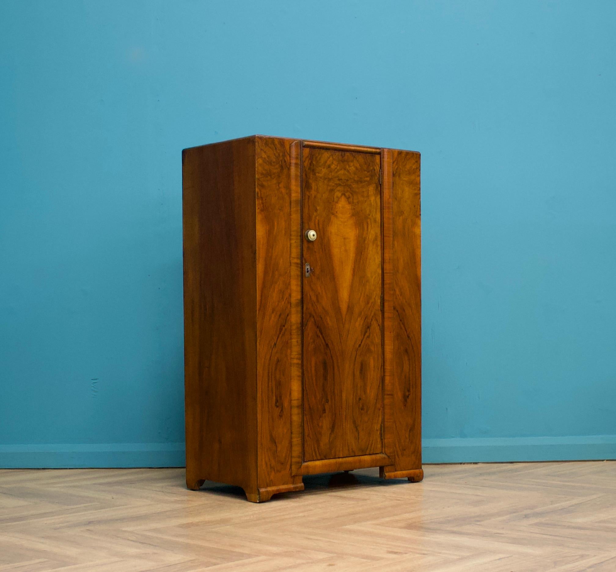 An Art Deco style compact walnut wardrobe - circa 1950's
Fitted out with a clothes rail