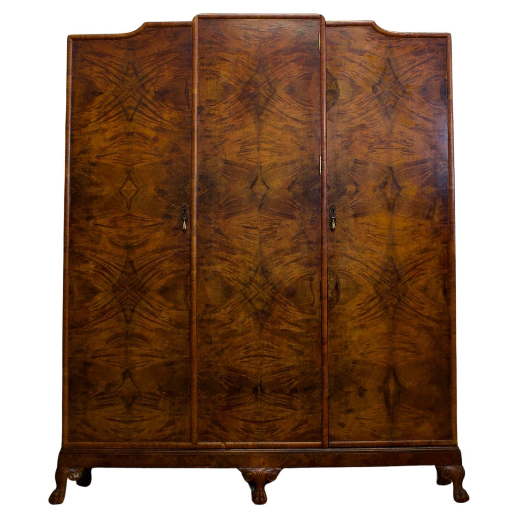 An impressive quality, 1930's burr walnut triple door wardrobe - perfect for a maximalist interior

This piece is Art Deco in style, with influences of Art Nouveau

The interior is beautifully fitted with a hanging rail and shelf to the larger