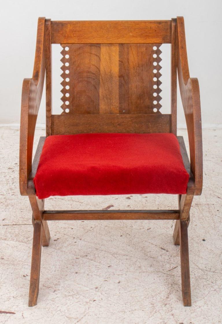 British Arts and Crafts oak Glastonbury chair after the A.W.N. Pugin (British, 1812-1852) original designed 1840, and based on the model made for Richard Whiting, last Abbot of Glastonbury, with typical square back, scalloped and reticulated splat