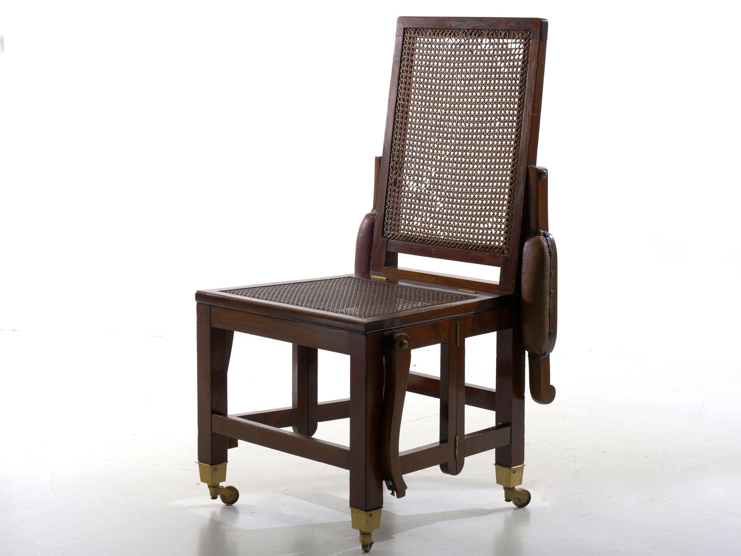 A RARE VICTORIAN CAMPAIGN MAHOGANY AND LEATHER METAMORPHIC ARMCHAIR
England, circa 1840-60; seat stamped 