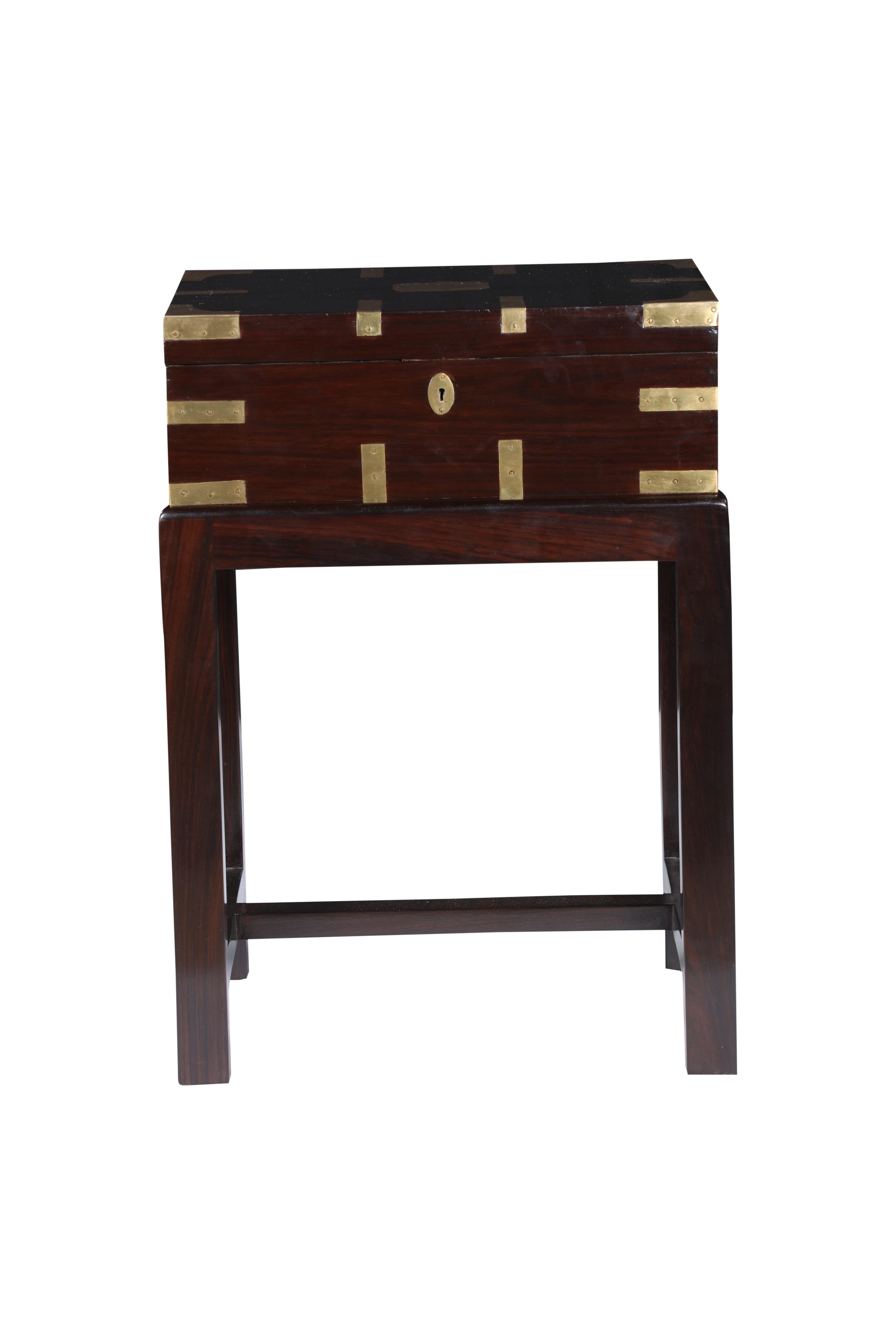 A handsome, rosewood British Campaign officer's chest on a custom made stand. It features the brass strap corners are typical of the the Campaign pieces. It has a fitted interior for use by the officer for his personal effects. Dates to the early