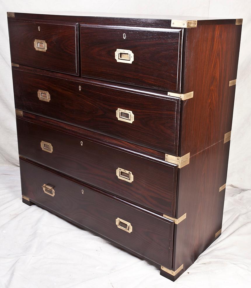 British Campaign rosewood chest of drawers, in two parts of course, with flush drawer pulls and brass strap corners, early 1900s, refinished.