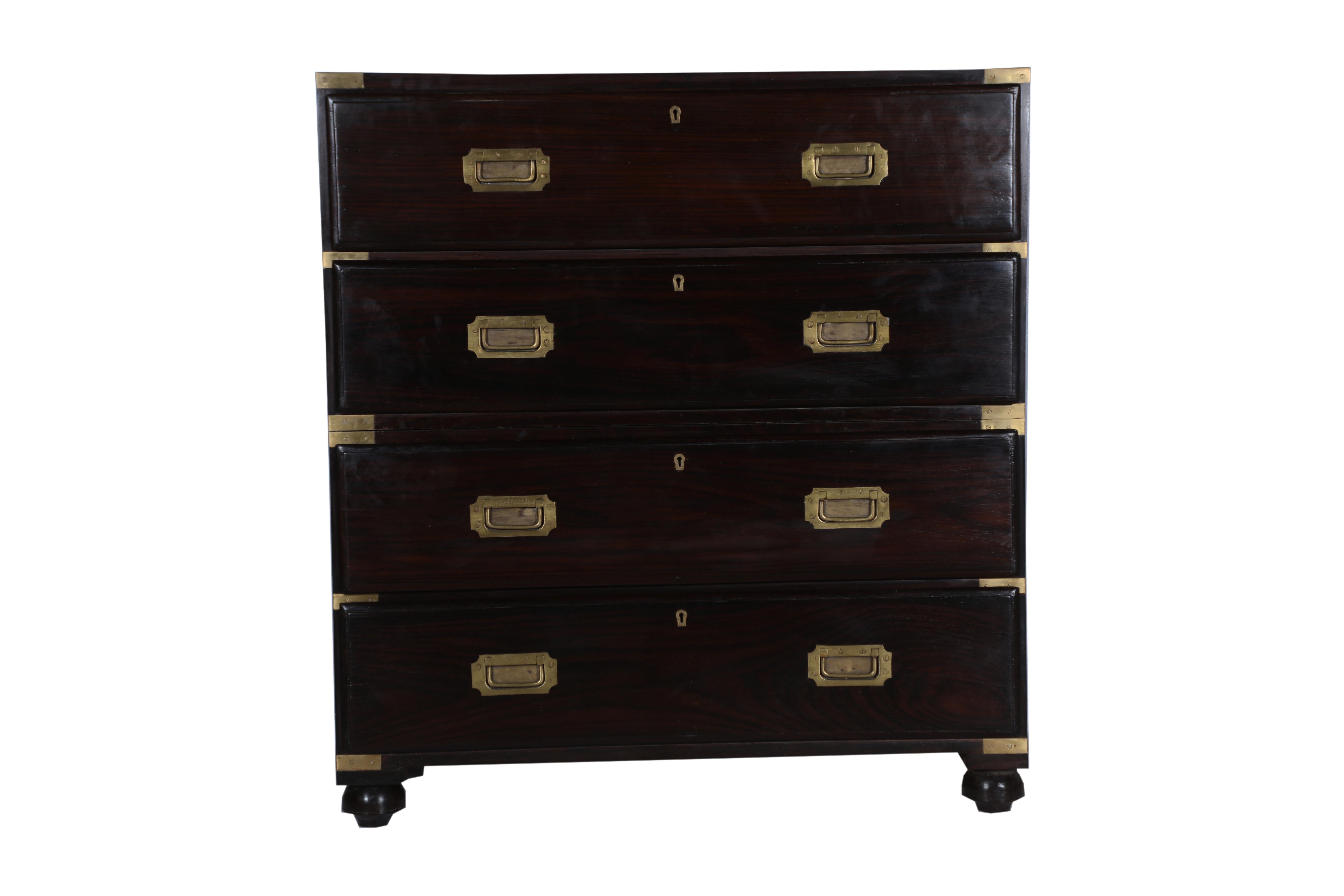 A handsome and elegant British Campaign rosewood secretary and chest of drawers. Divided into two lower and upper halves as most Campaign pieces do, brass strap corners and flush brass drawer pulls.
The desk portion falls at 30