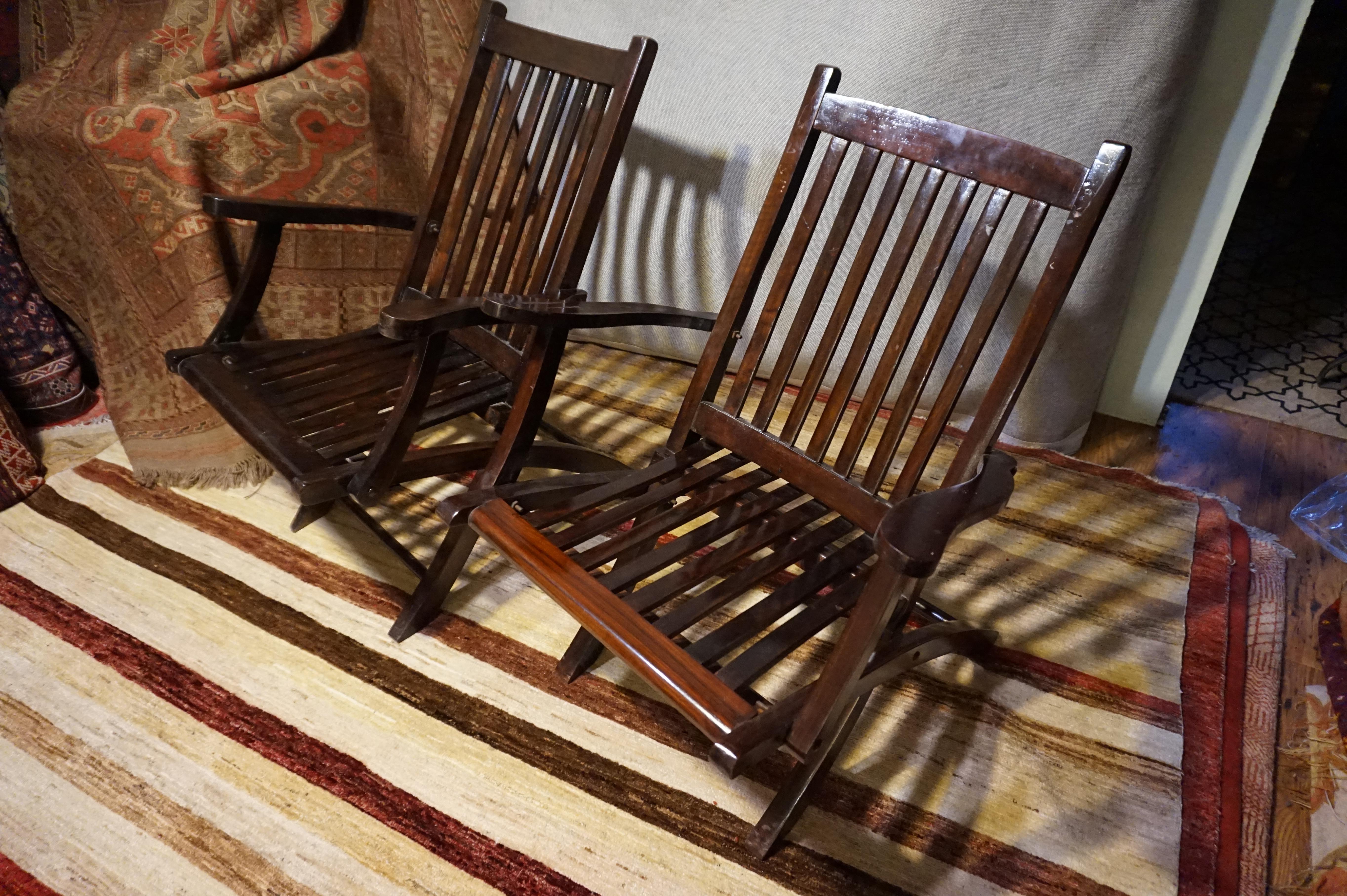 Circa 1910-20
Hand made, solidly built British campaign teak and rosewood folding chairs on bolts. Flowing wood grain. Sturdy construction. Once opened bolts should be gently tightened for long term use.