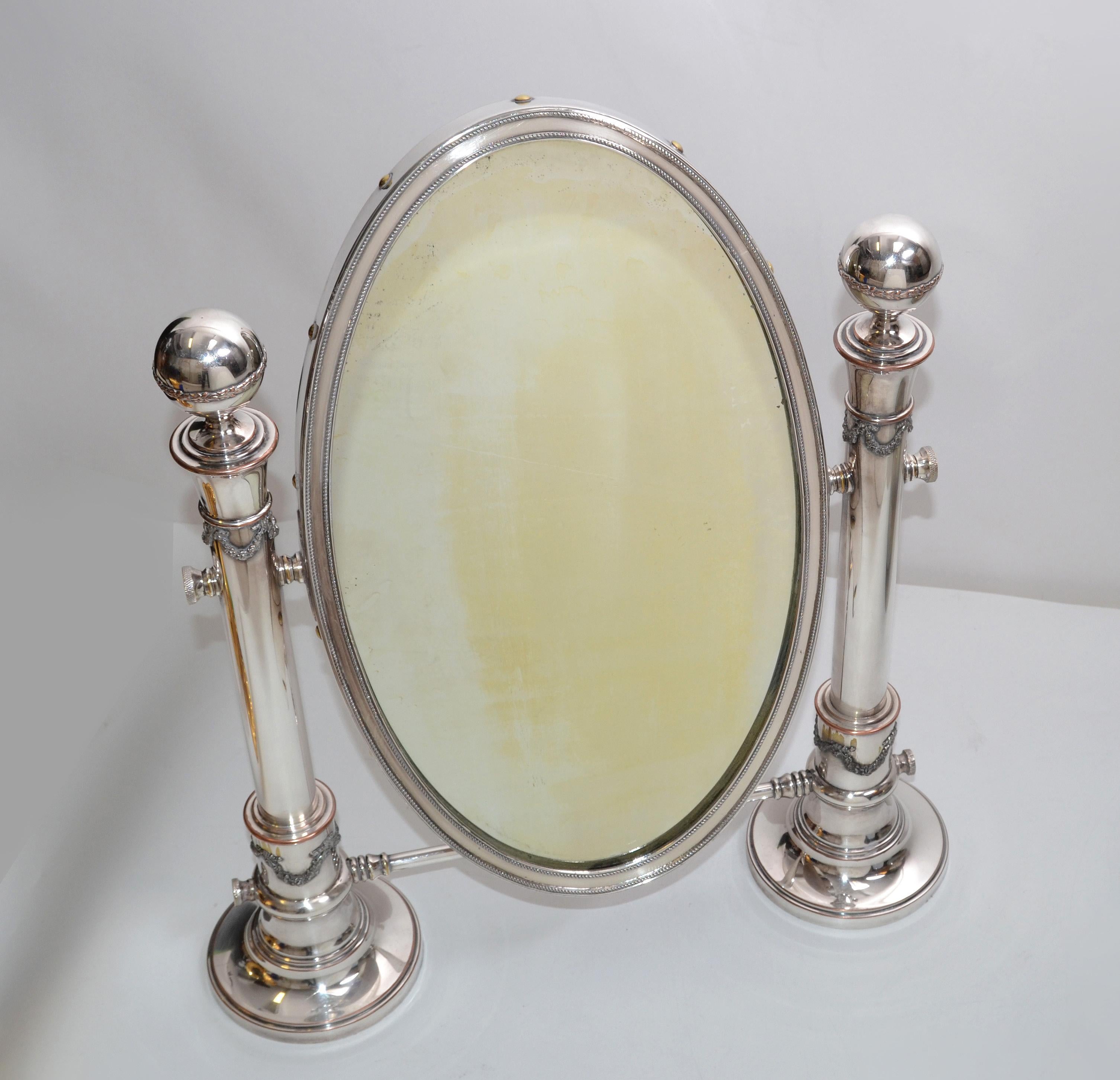 Silver plate oval vanity mirror or table mirror with ornate pedestals circa 1910 Sheffield, England.
The back is made of solid wood.
Makers trademark at the side of the Mirror.
Mirror size: 9 x 15 inches.