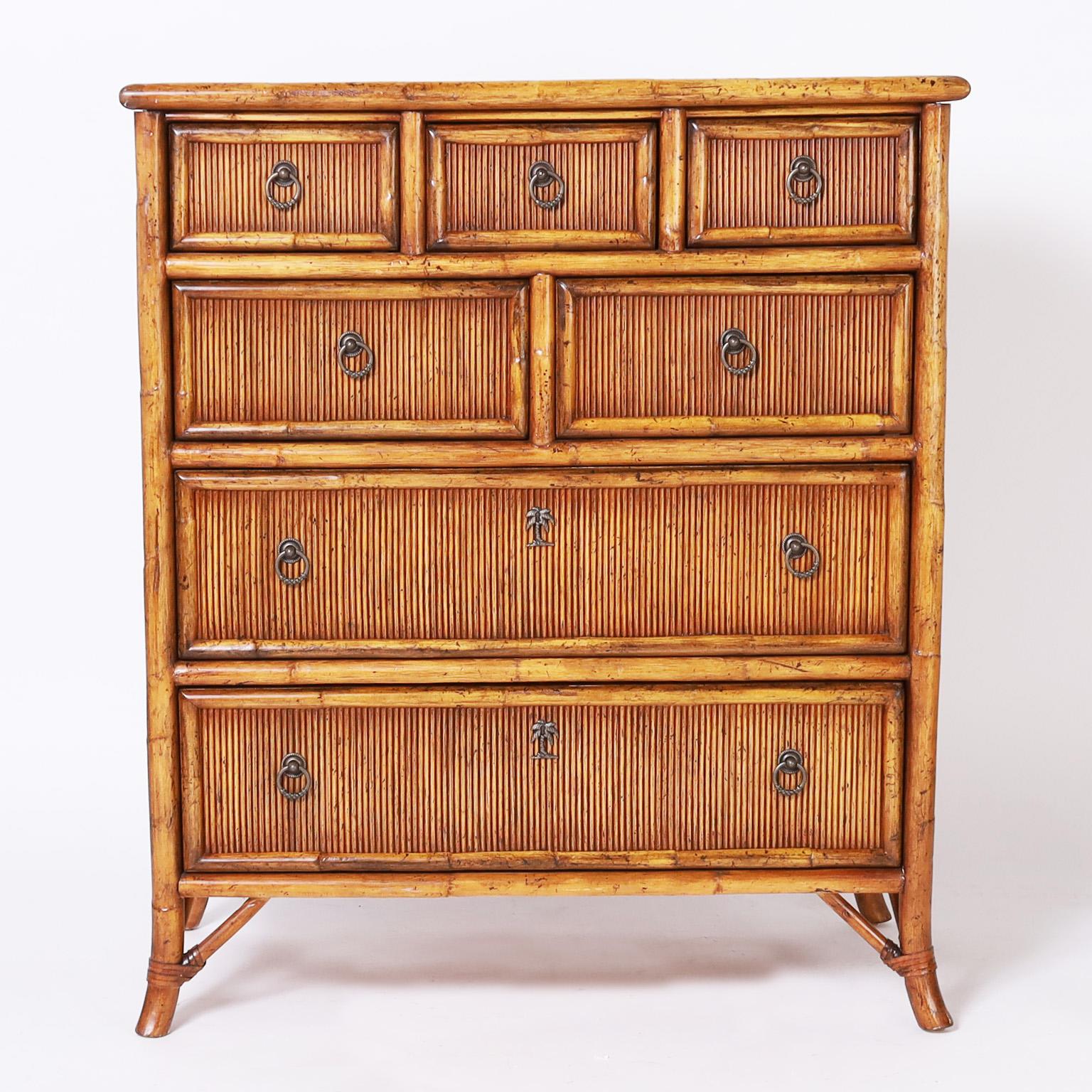 Impressive British colonial style chest with seven drawers, crafted with a bamboo frame having pencil reed panels on the top sides and drawer fronts, brass hardware and splayed legs. Signed Greenbaum Interiors in a drawer.