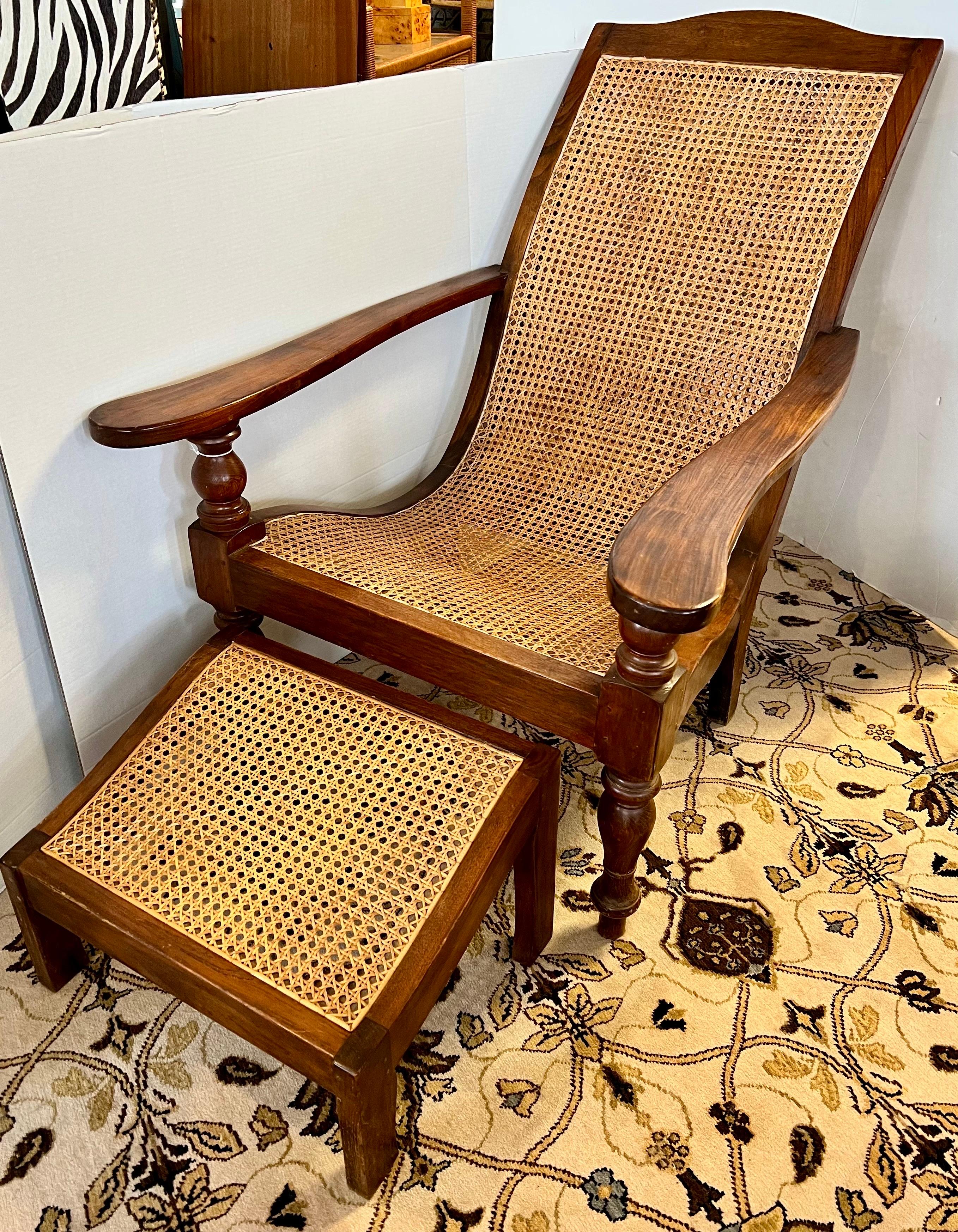 Vintage British Colonial plantation chair with matching ottoman that features carved mahogany frame and cane seat with signature coveted sloping backrest.
Ottoman is 20