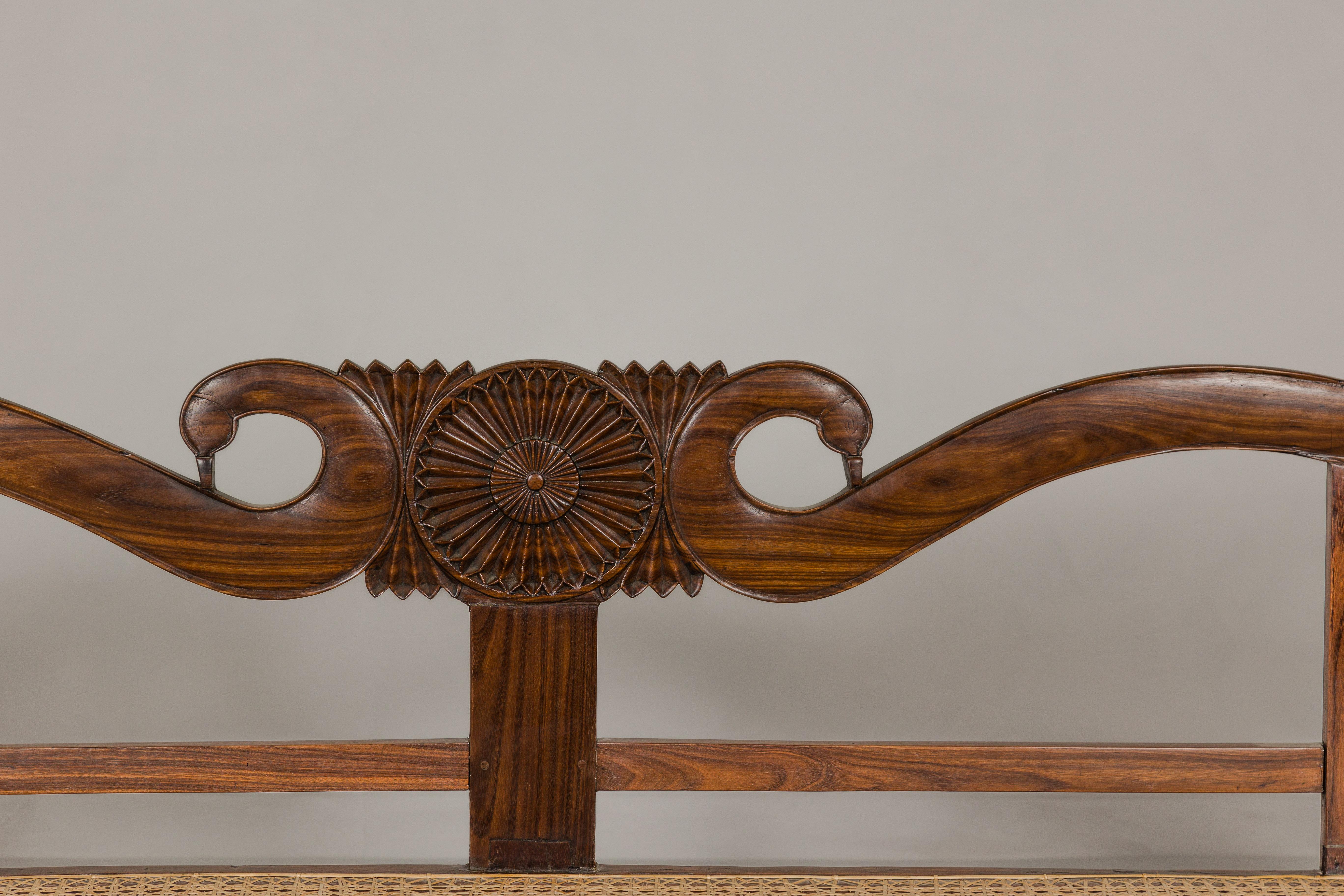 20th Century British Colonial Carved and Cane Settee with Swan Neck Back and Scrolling Arms For Sale