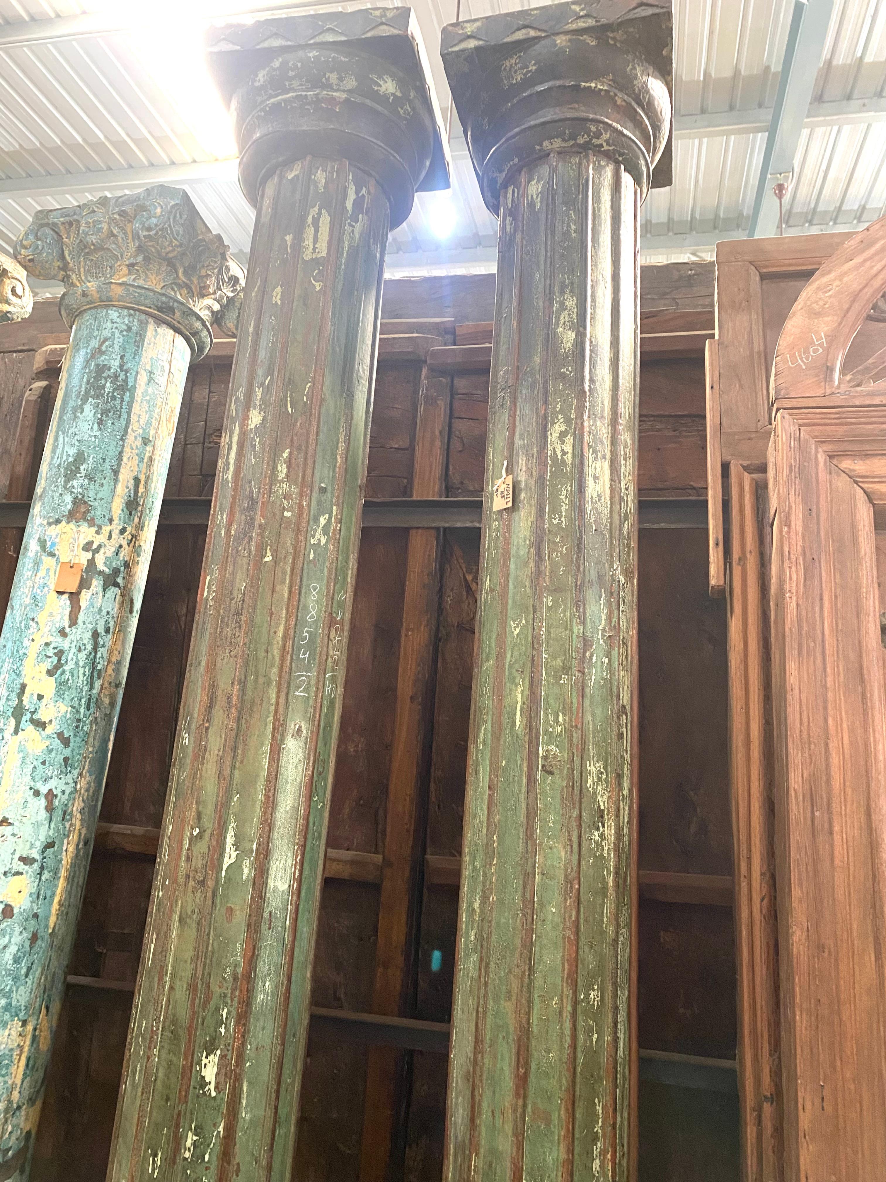 This extraordinary pair of 2 columns is made of teak wood with nice vintage patina. The capitals and stone basis feature scarved geometrical paterns.
Each column is composed of 3 parts to assemble a granit basis, à column and capital which fit