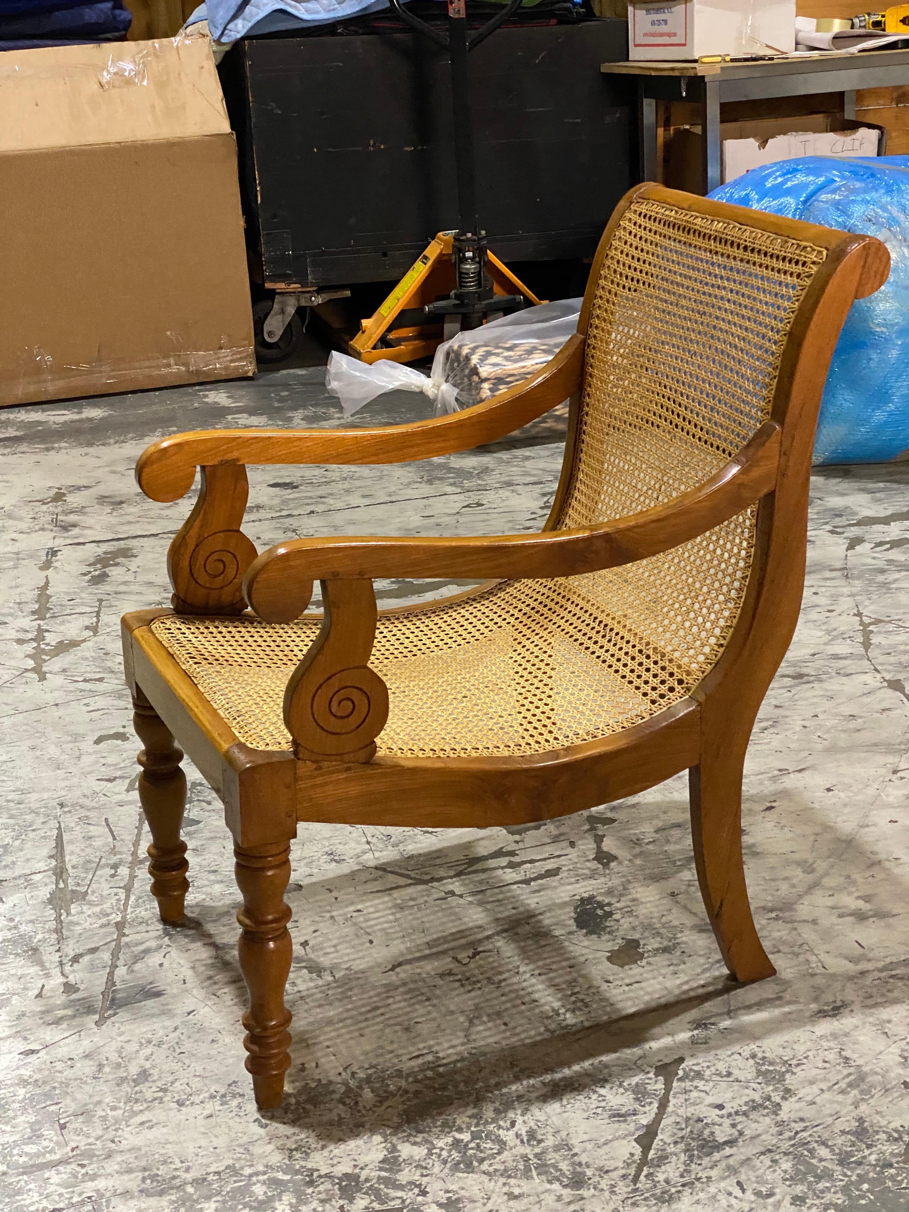 British Colonial Ceylonese Solid Satinwood & Hand Caned Armchair
Made entirely out of satinwood.  Gentle curved back. Hand caning seat - still in good condition. Spiral arms are a unique detail on this chair.  Front legs are turned, back splay out.