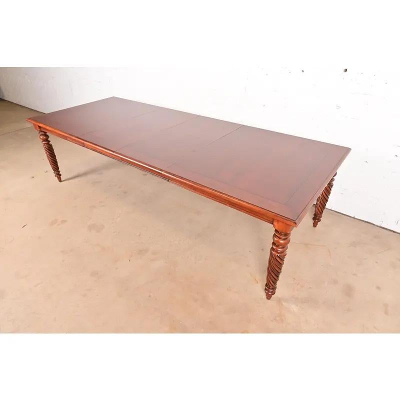 A beautiful British Colonial, Early American, or Victorian style extension harvest style dining table

Early 21st Century

Solid cherry wood, with turned legs.

Measures: 72