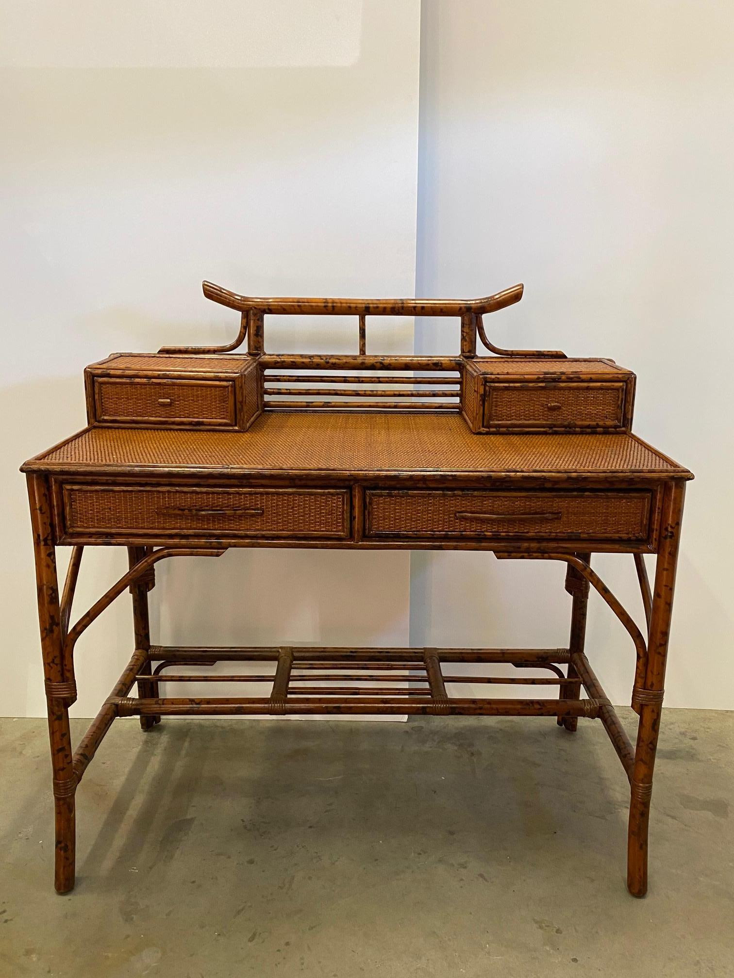 Stunning writing desk and matching chair in the British Colonial style having a smart combo of grass cloth wrapping and faux bamboo.
Chair measures 38.5 H 19.5 W 17 D seat height 17
Desk opening 25.